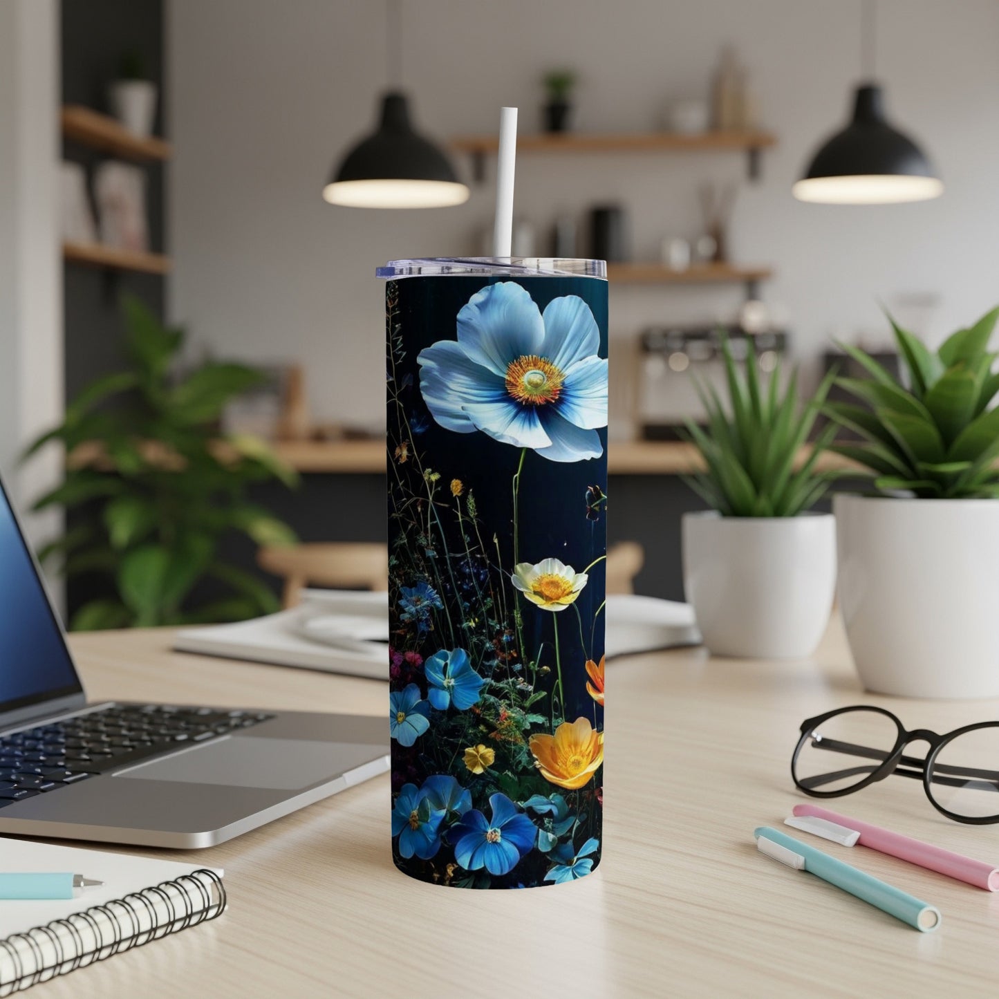 Tall tumbler with blue and yellow wildflowers on a dark background.