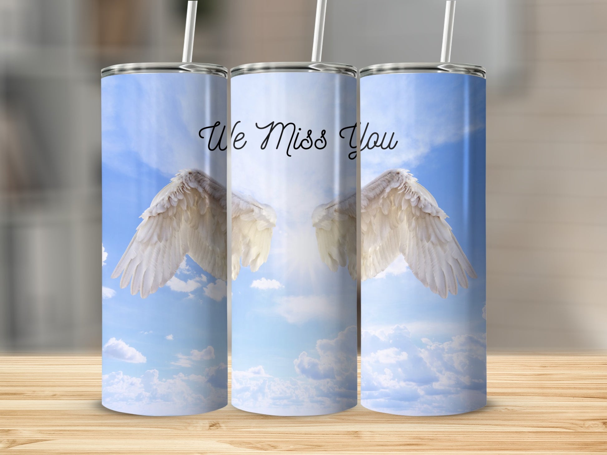 Angel wings with "We Miss You" text on a bright sky background.