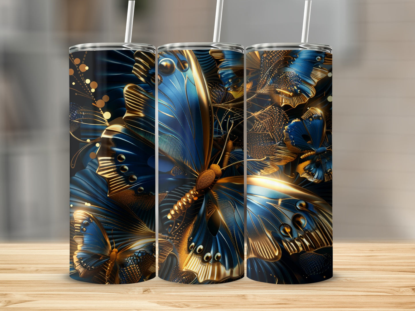Three tall tumblers with blue and gold abstract butterfly designs.