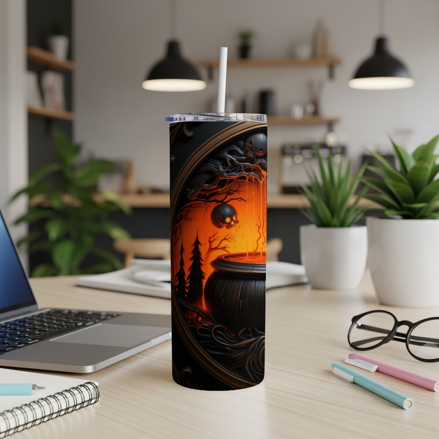Tumbler with a spooky Halloween cauldron and skull design.