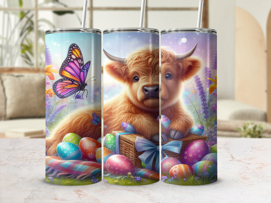 Fluffy Highland calf with Easter eggs and butterfly on straw.