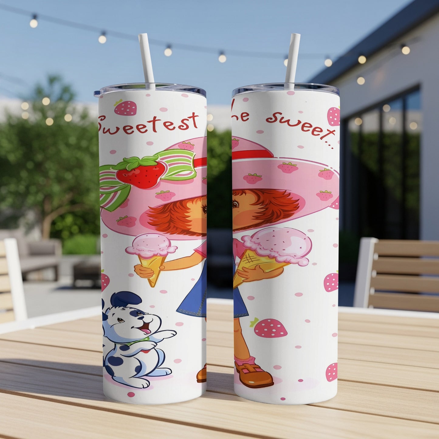 Strawberry Shortcake holding ice cream with cartoon dog on a pink patterned tumbler.