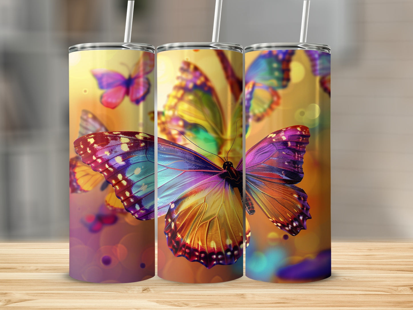 Three tumblers with colorful butterfly designs and bokeh lighting.