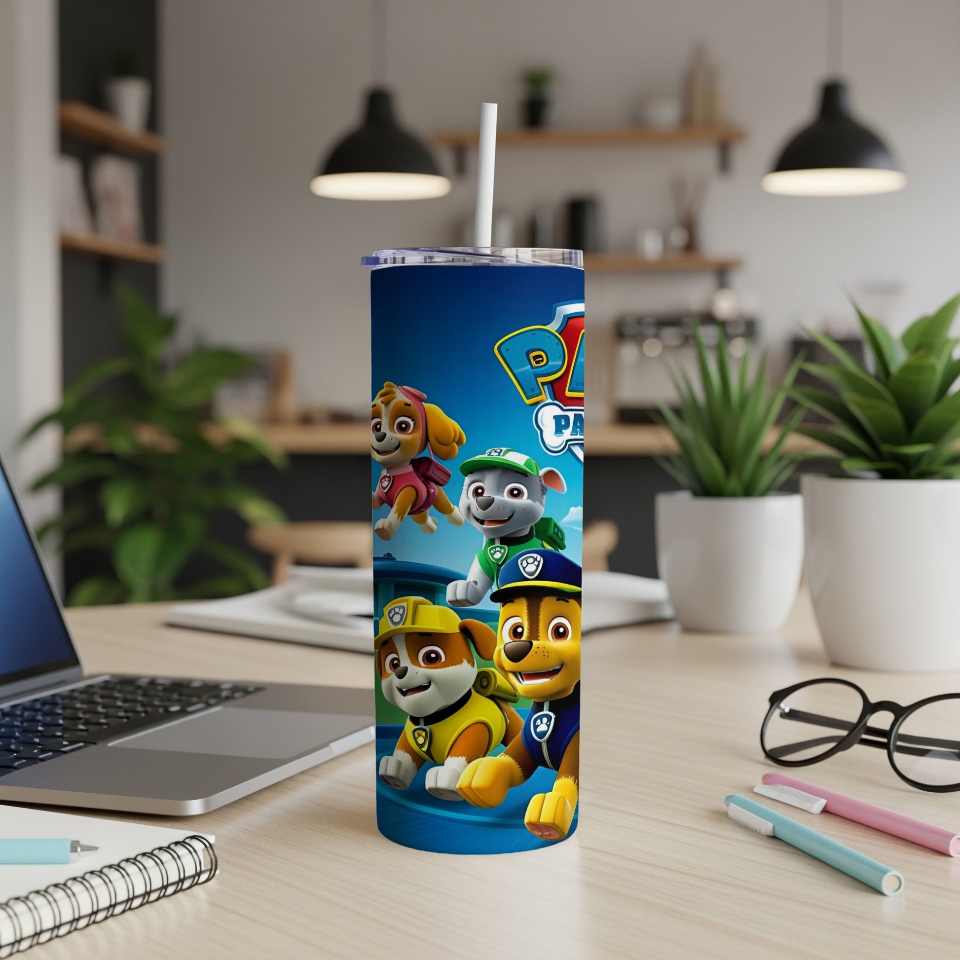 Paw Patrol characters Ryder, Chase, Marshall, and Skye on a blue tumbler with white lid and straw.