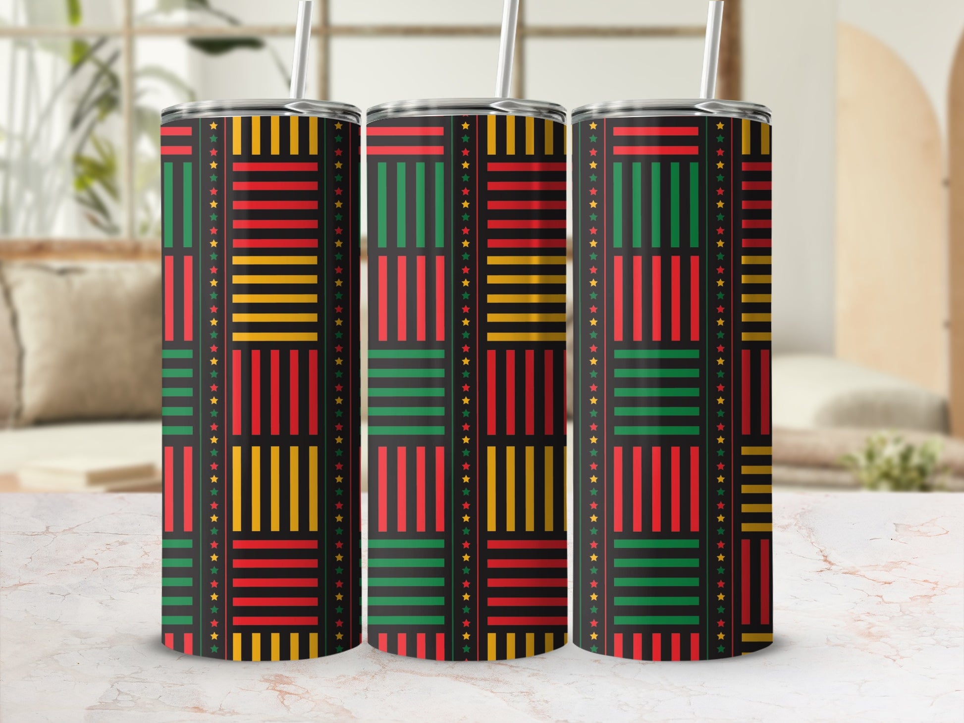 Three tumblers with a black background and a Kente-inspired pattern of red, yellow, and green stripes and stars.