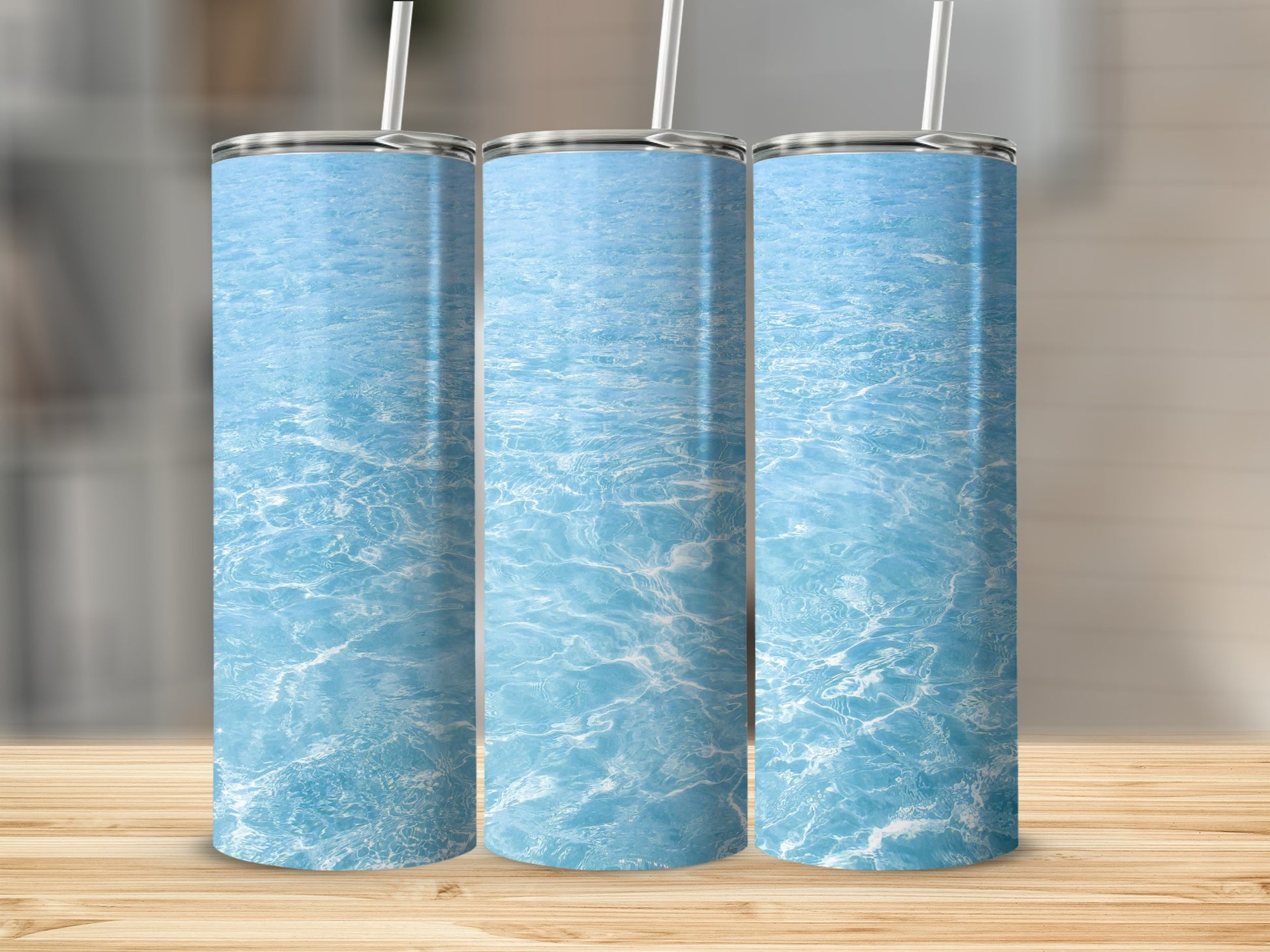 Three tumblers with a rippling blue water surface design.