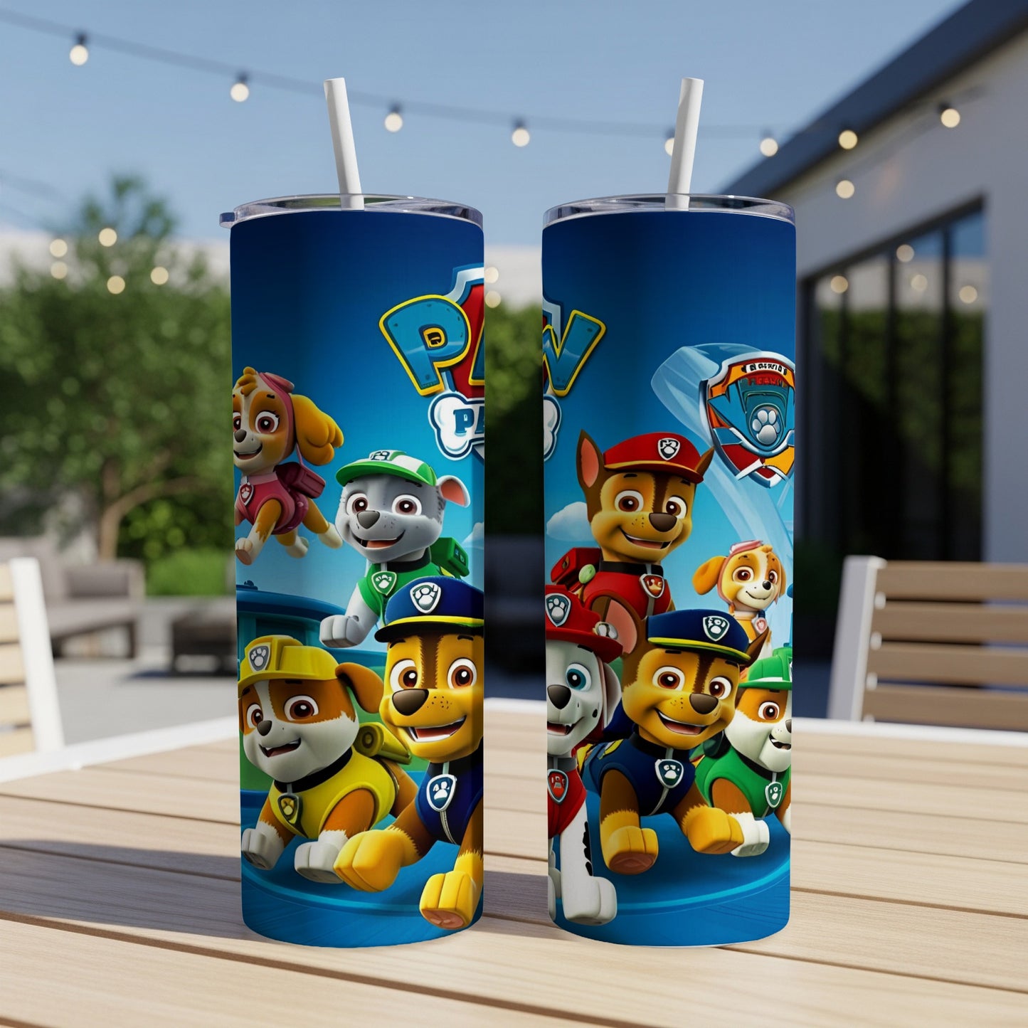 Paw Patrol characters on a blue tumbler with a straw, outdoors.