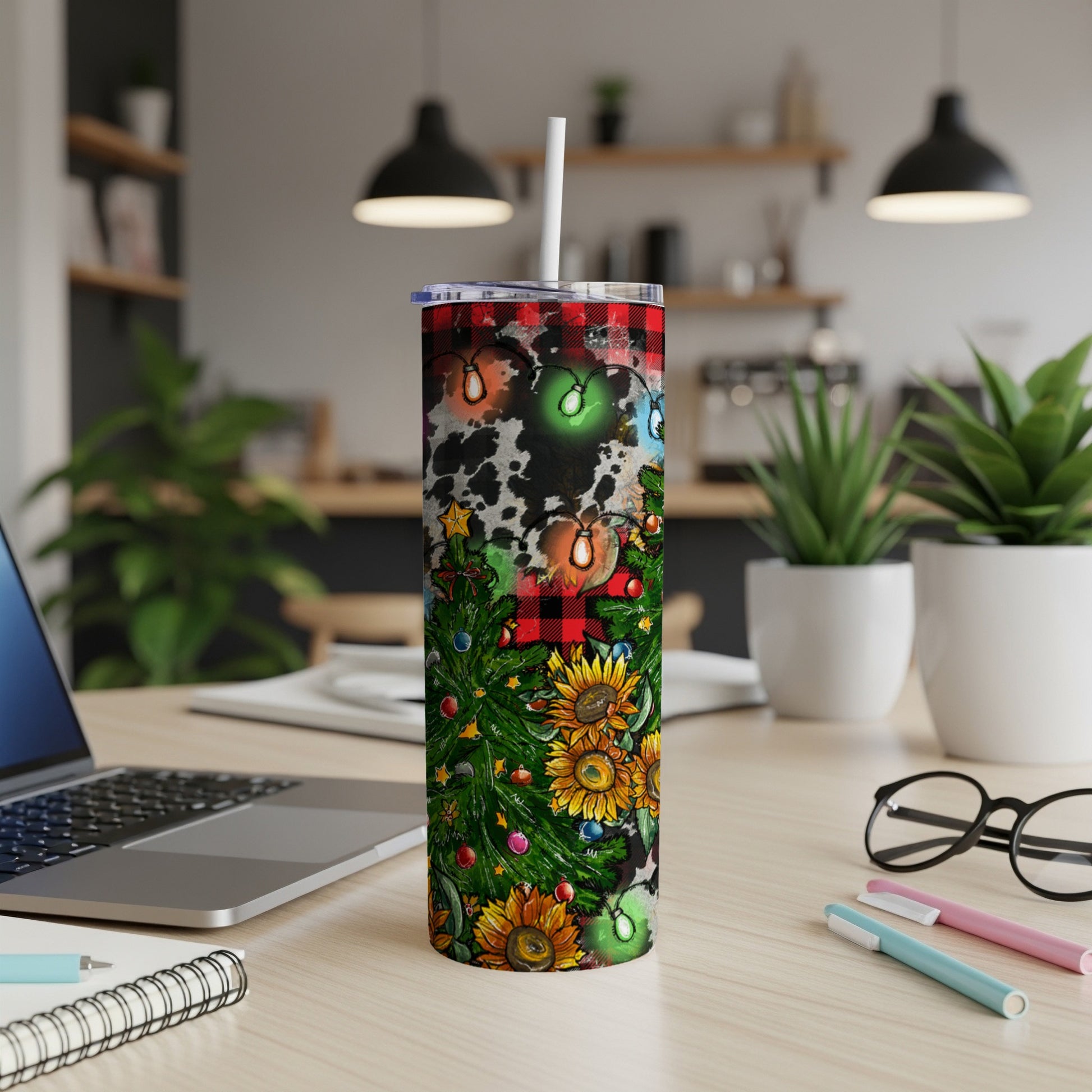 Christmas tree and sunflowers on a cow print tumbler with lights.