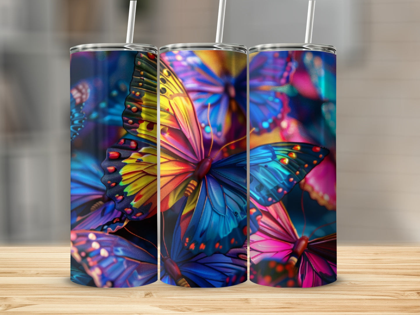 Three tumblers with vibrant, colorful butterfly designs.