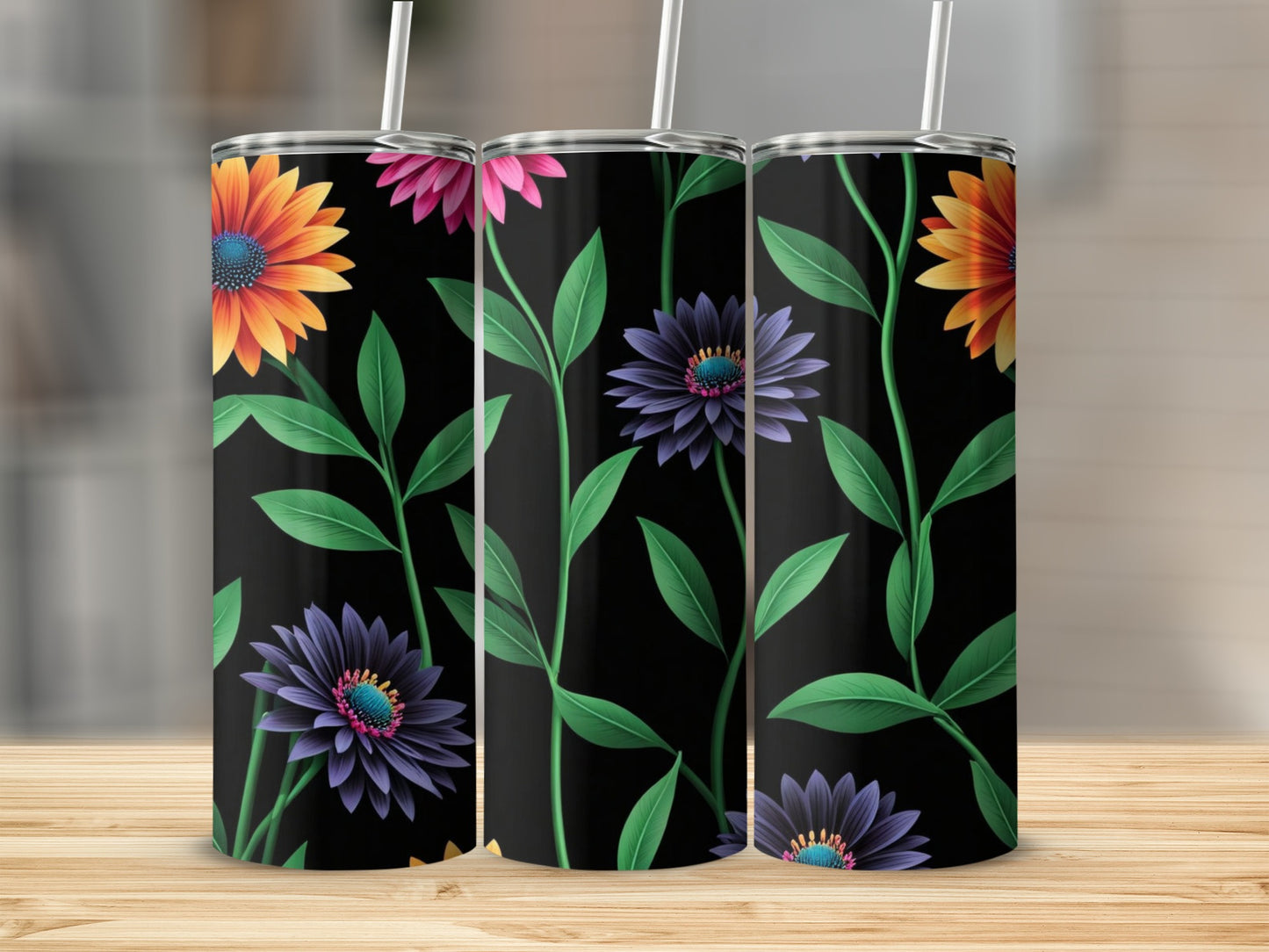 Three tumblers with a black background and a floral pattern of orange and purple flowers.