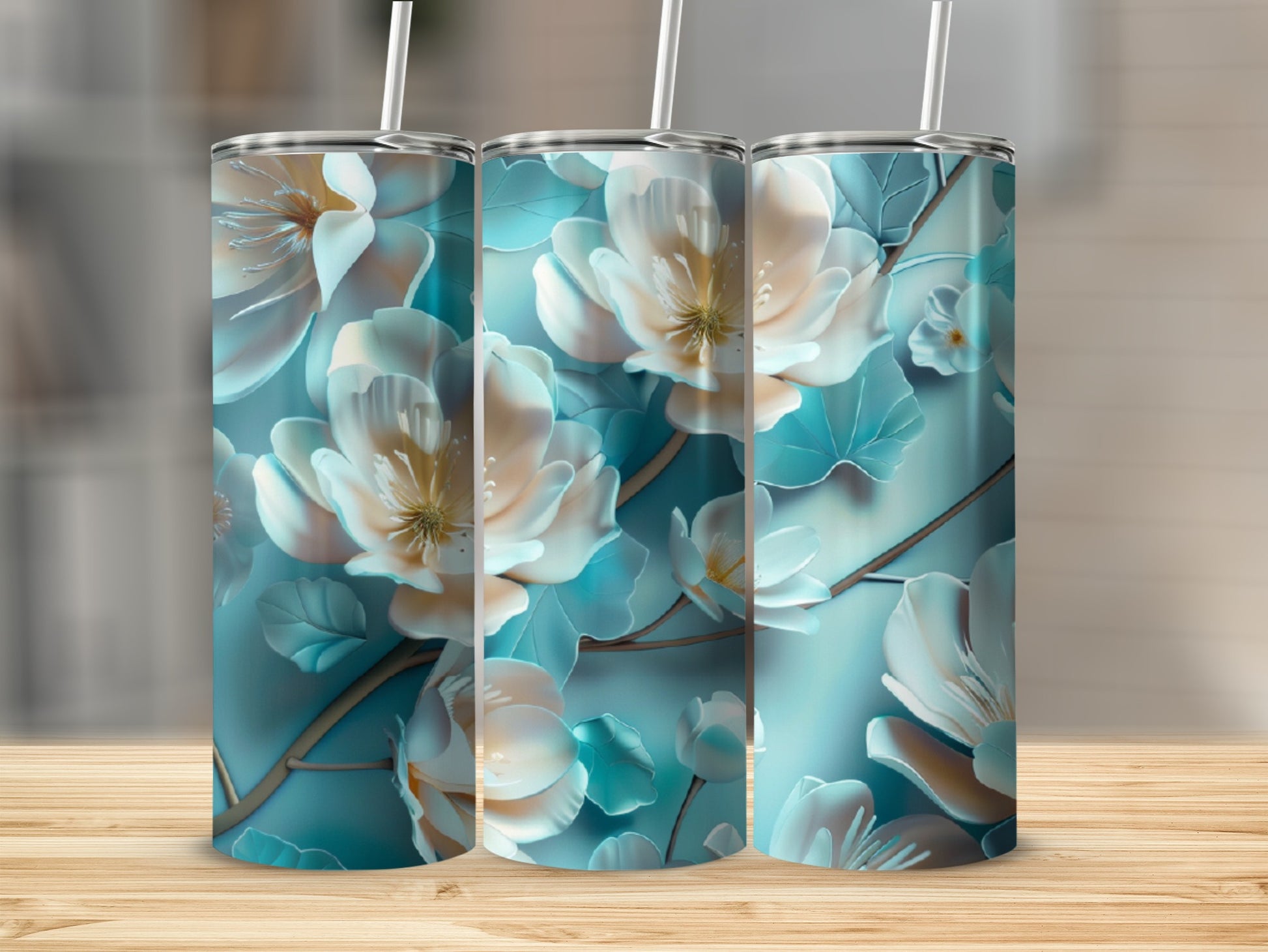 Three tumblers with white and blue floral patterns on a wooden surface.