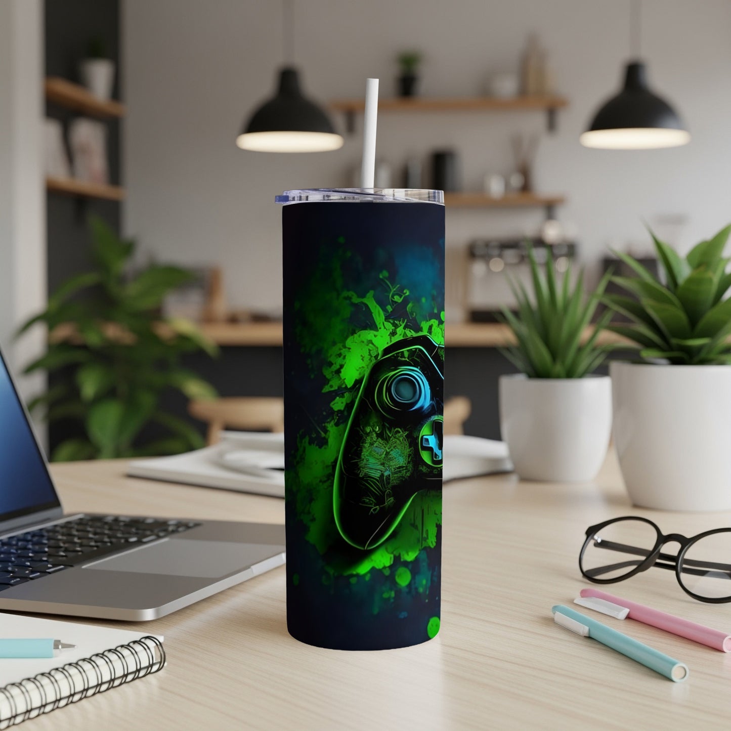 Black tumbler with green abstract splatter pattern and game controller graphic.
