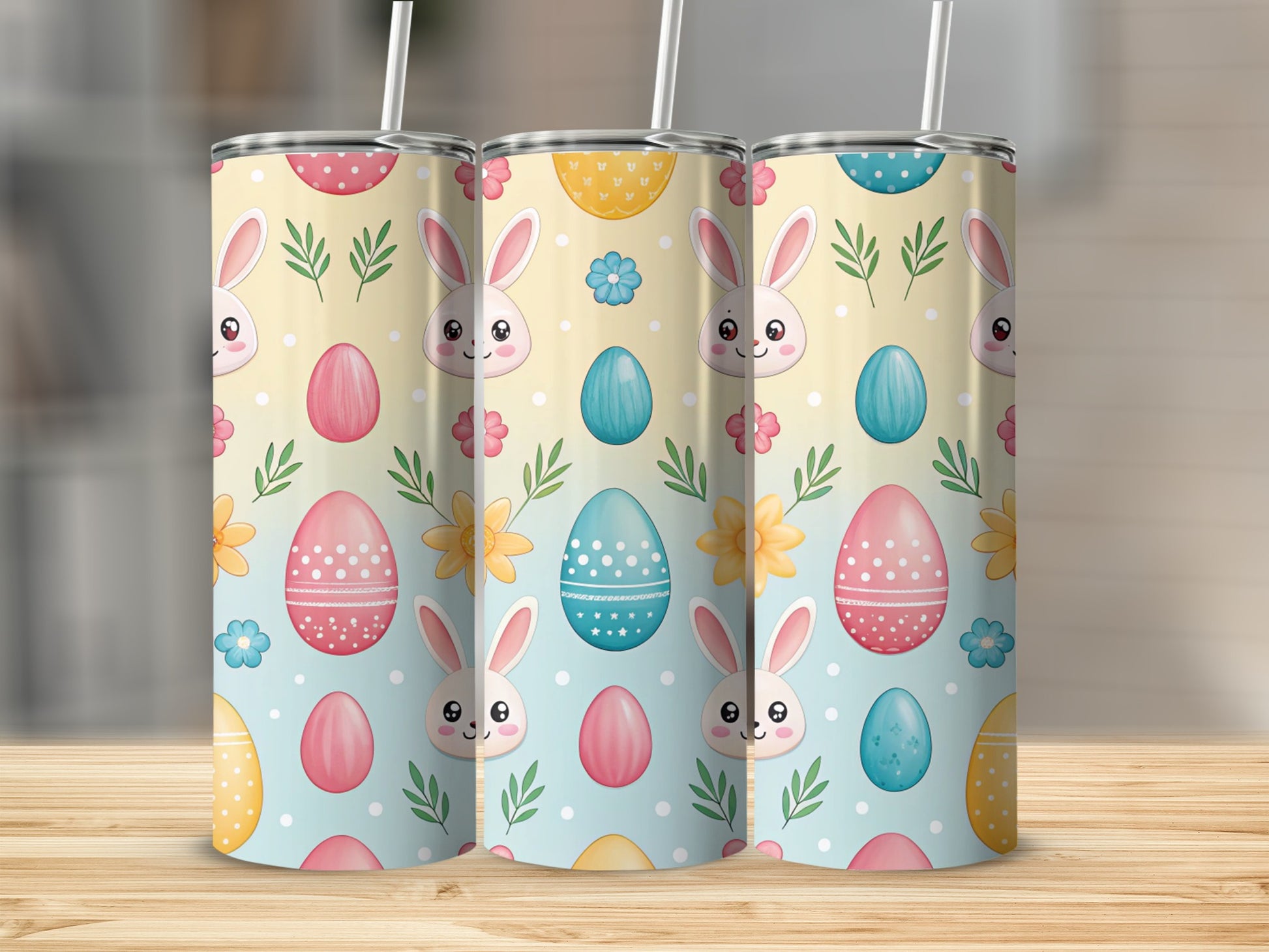Three tumblers with Easter bunny and egg pattern on a wooden surface.