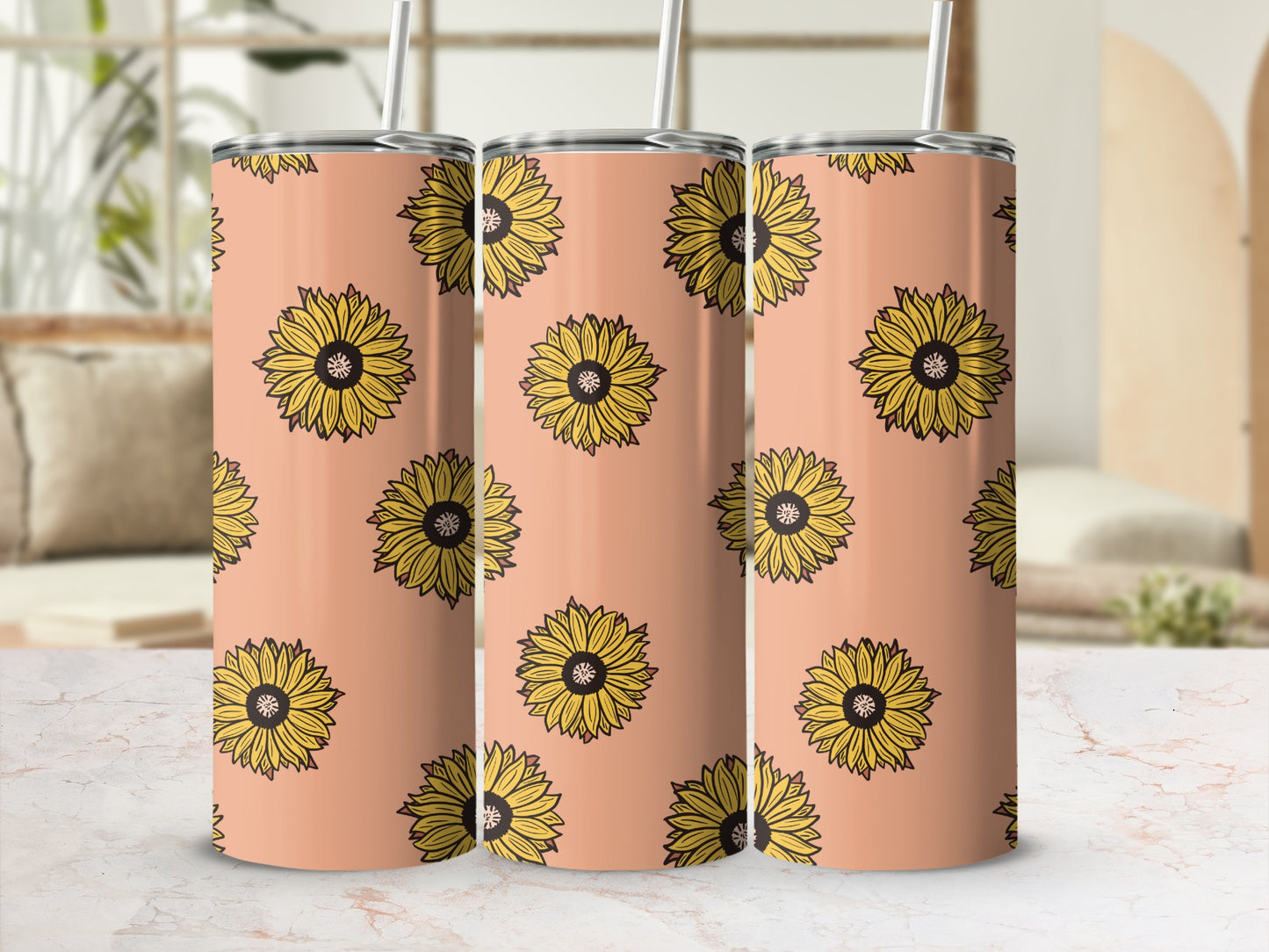 Three peach tumblers with a repeating yellow sunflower pattern and silver straws.