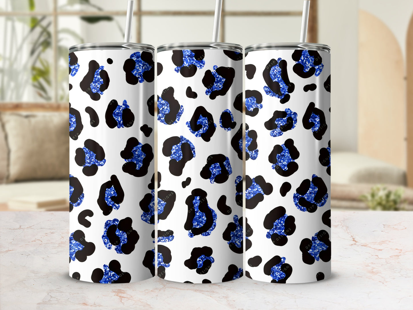 Blue leopard print tumbler with "DRYP DESIGNS" text.