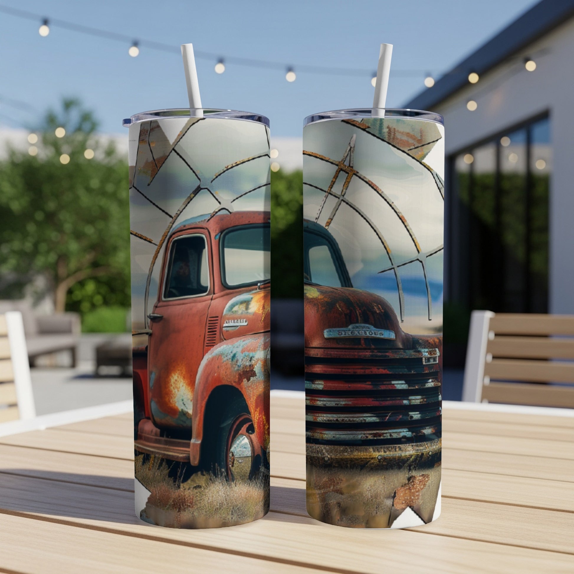 Rusty red vintage truck on a tumbler, with straw, outdoors.