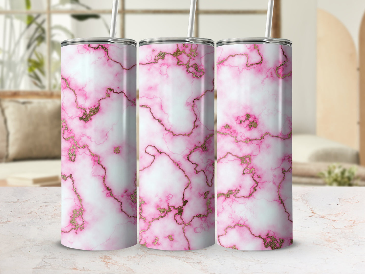 Pink and white marble tumbler with gold veining, shown on a marble countertop.