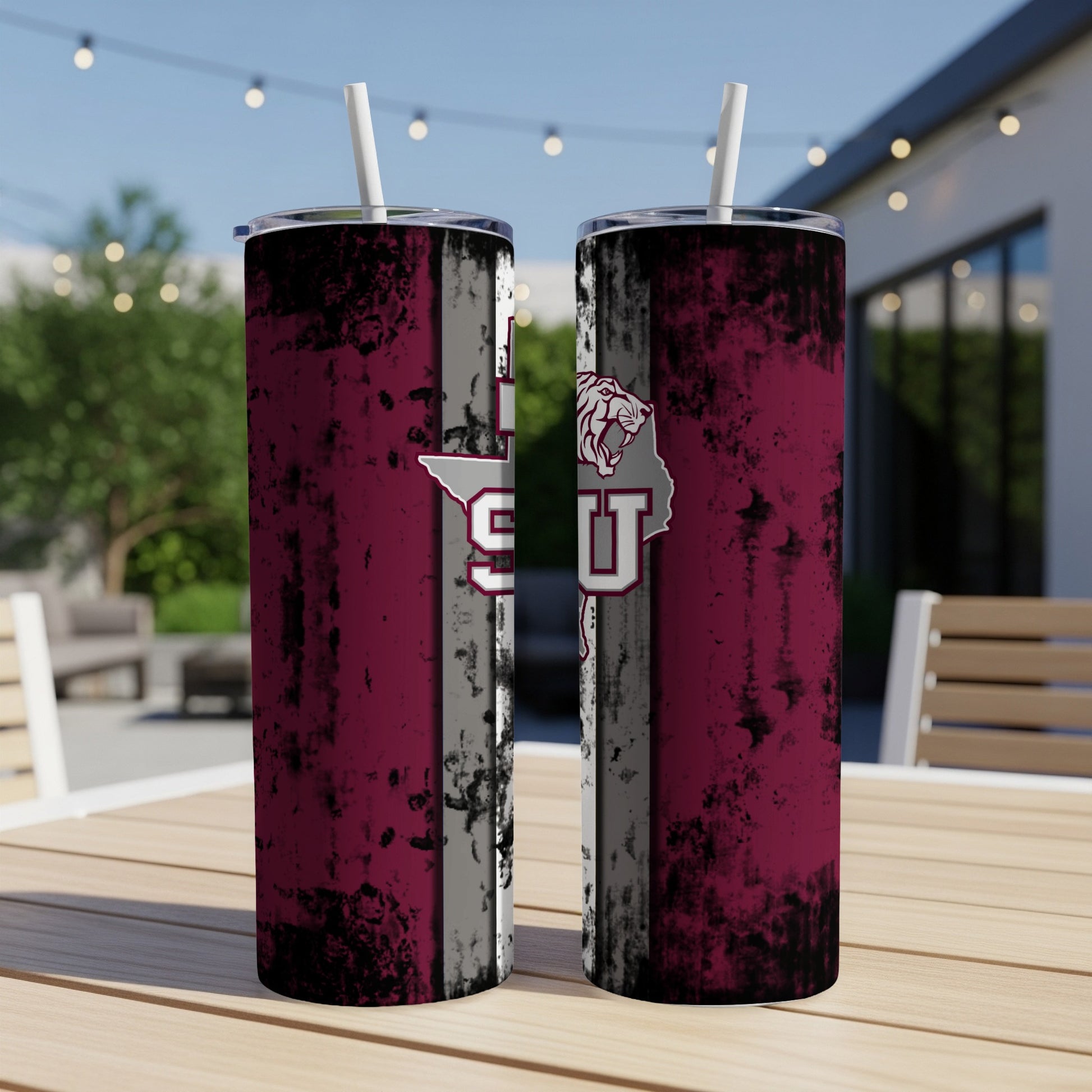 Two maroon tumblers with a distressed flag design and university logo.