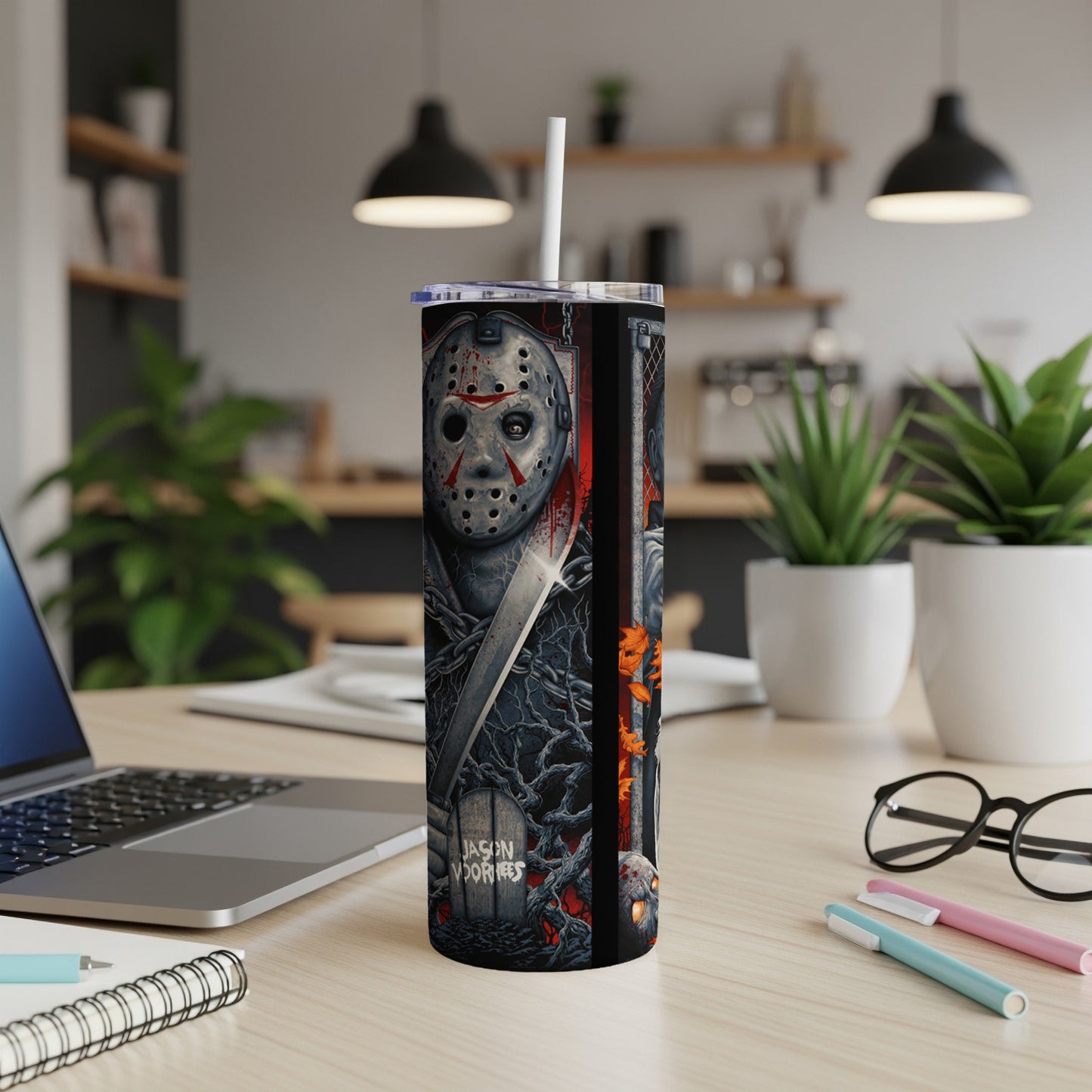 Jason Voorhees Halloween tumbler with straw on a desk.