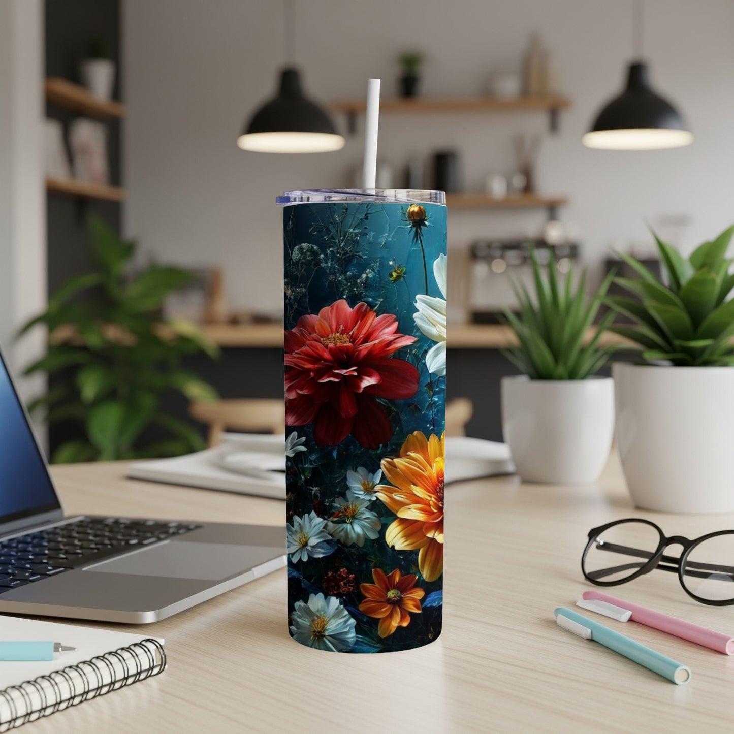 Tall tumbler with vibrant red, orange, and white flowers on a dark background.