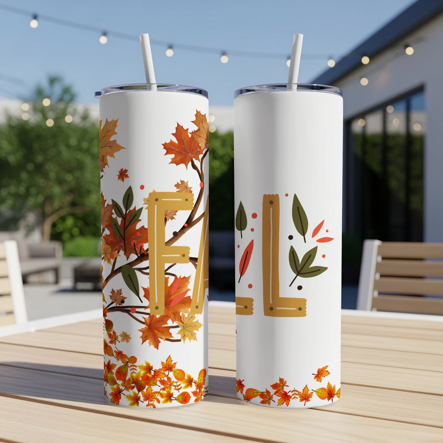 Two white tumblers with fall leaf designs and the word "FALL" in leaves.