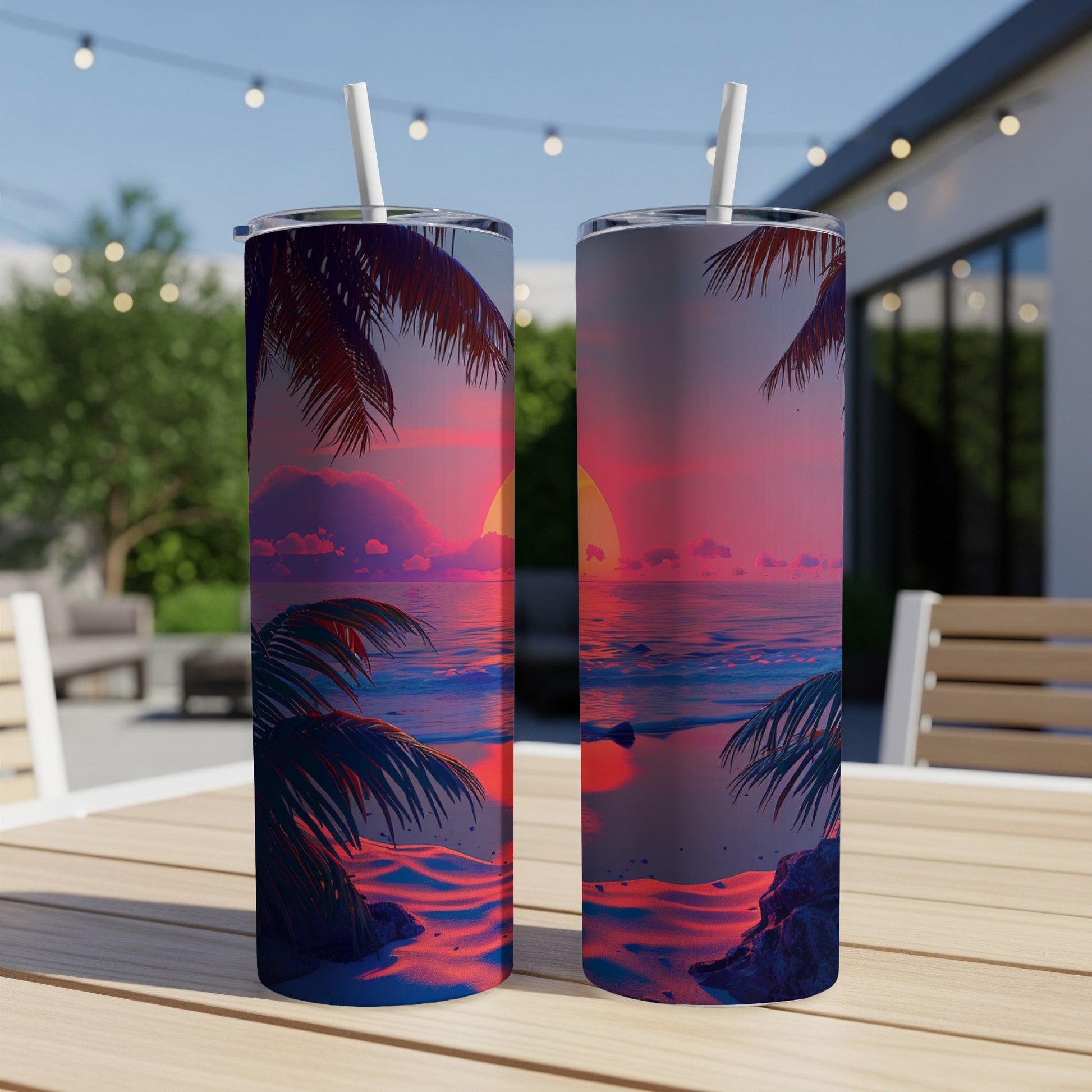 Two tumblers on a table with a sunset beach scene.