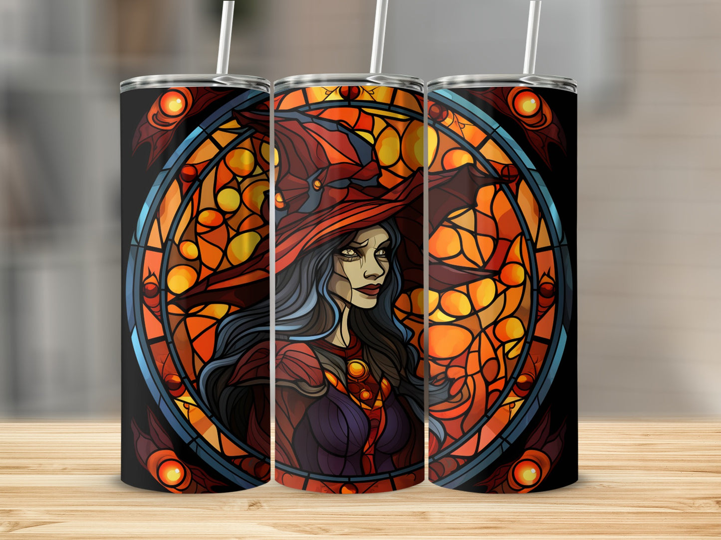 Three tumblers featuring a stained glass witch design on a wooden surface.