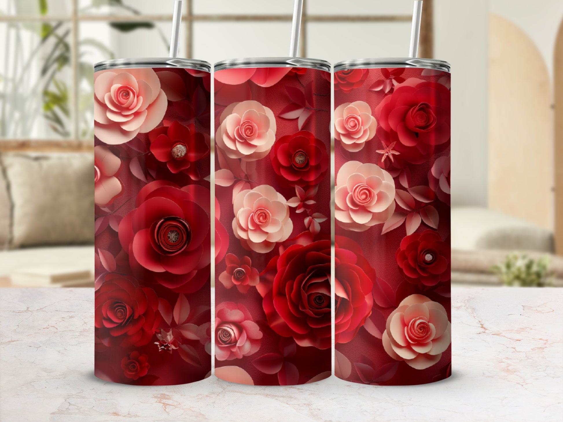 Three tumblers with a floral pattern of red and pink roses.