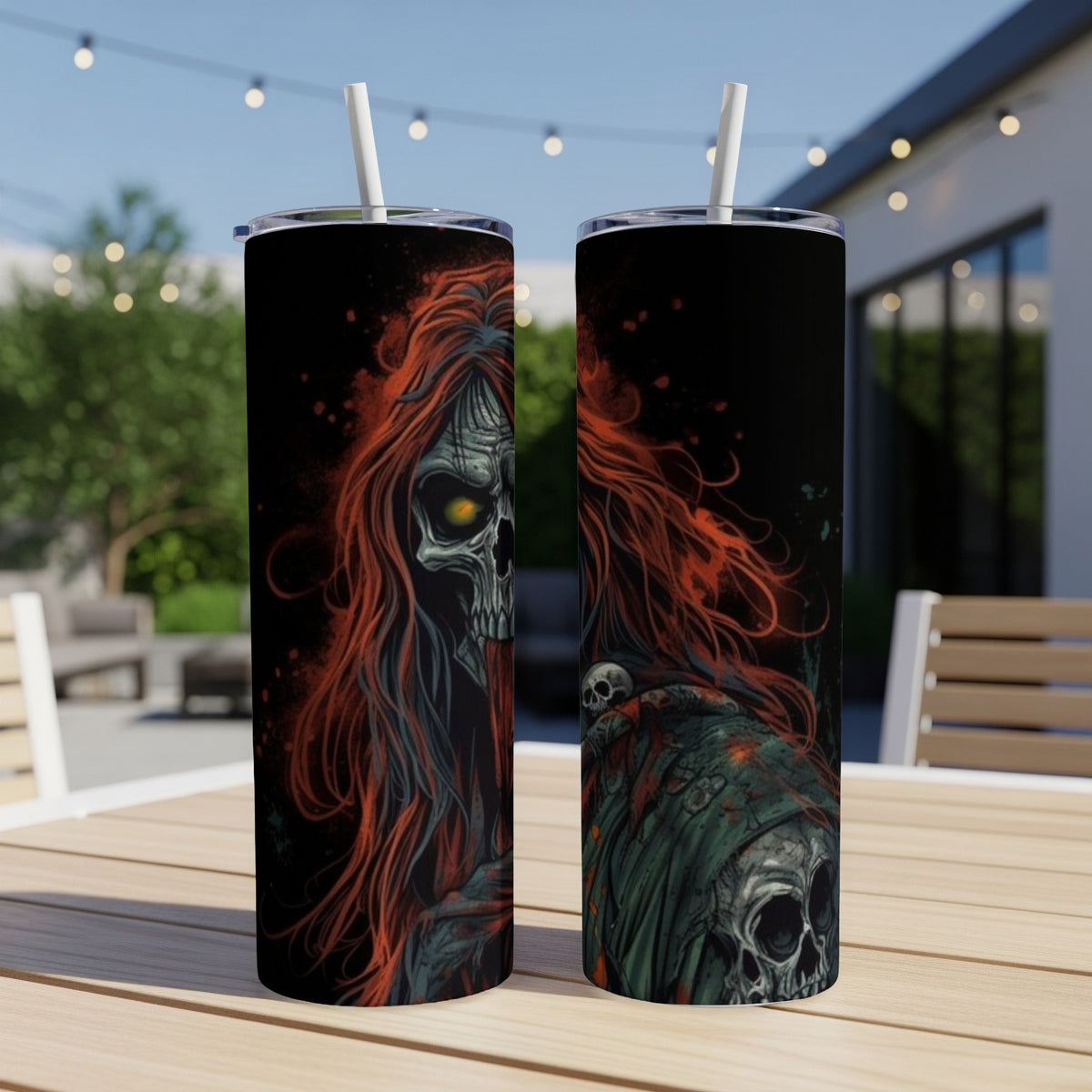 Two tumblers with a grim reaper and skeleton design on a table.