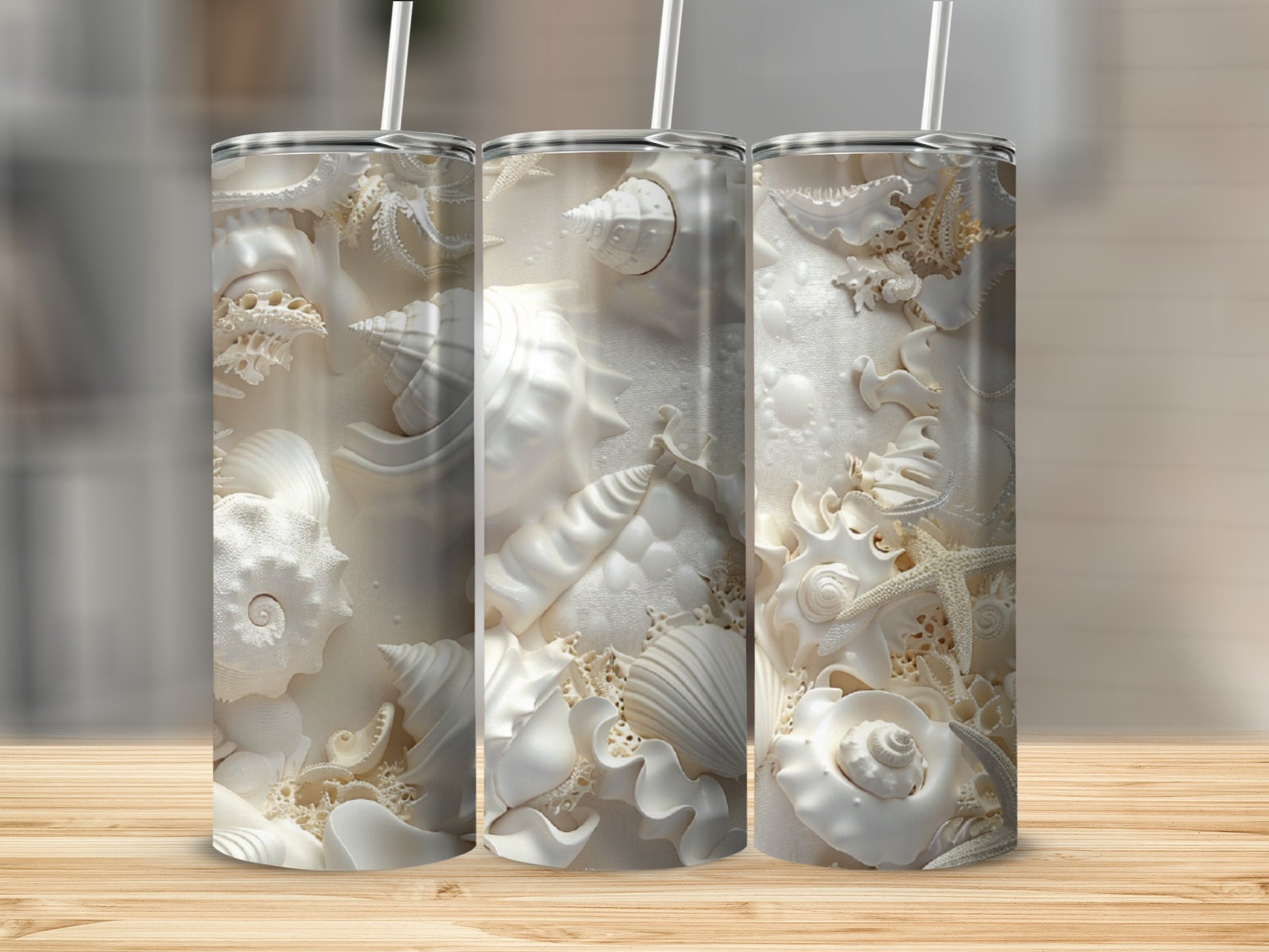 Three white tumblers with embossed seashell designs on a wooden surface.