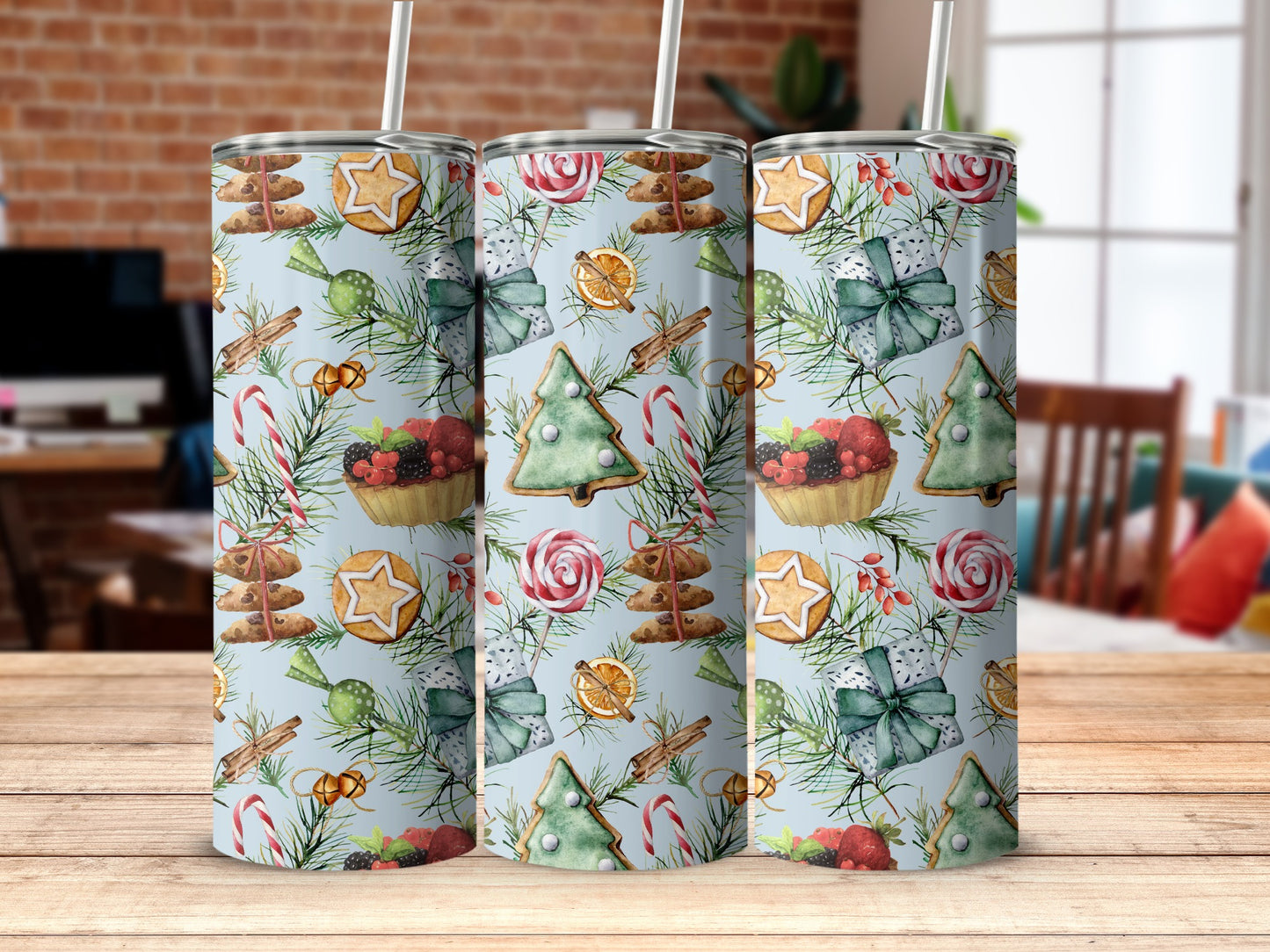 Three tall tumblers with a festive Christmas pattern of cookies, berries, and candy canes.