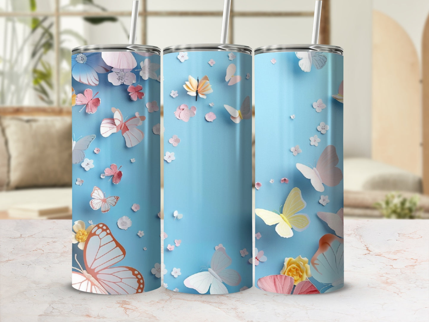 Blue tumbler with butterflies and flowers, featuring a pink butterfly prominently.