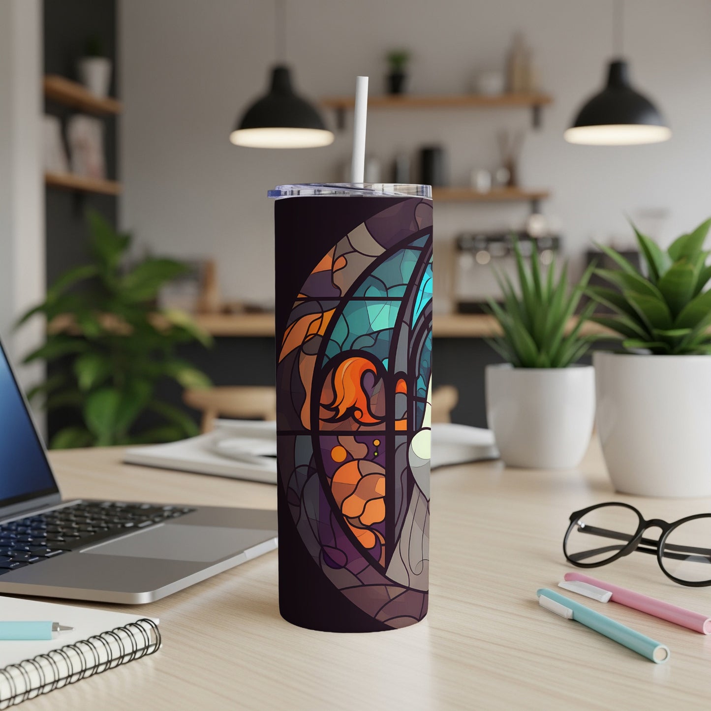 Stained glass tumbler with colorful abstract design and white straw.