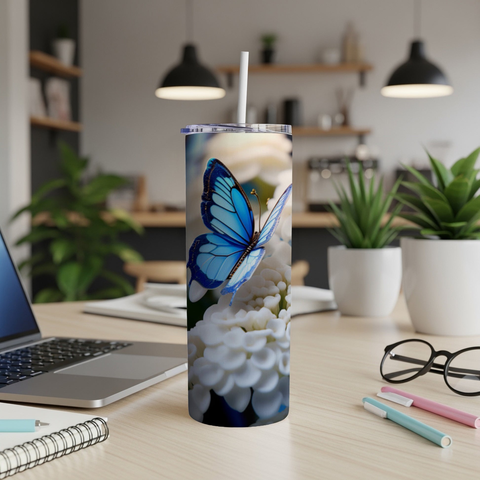 Blue butterfly on white flowers on a skinny tumbler.