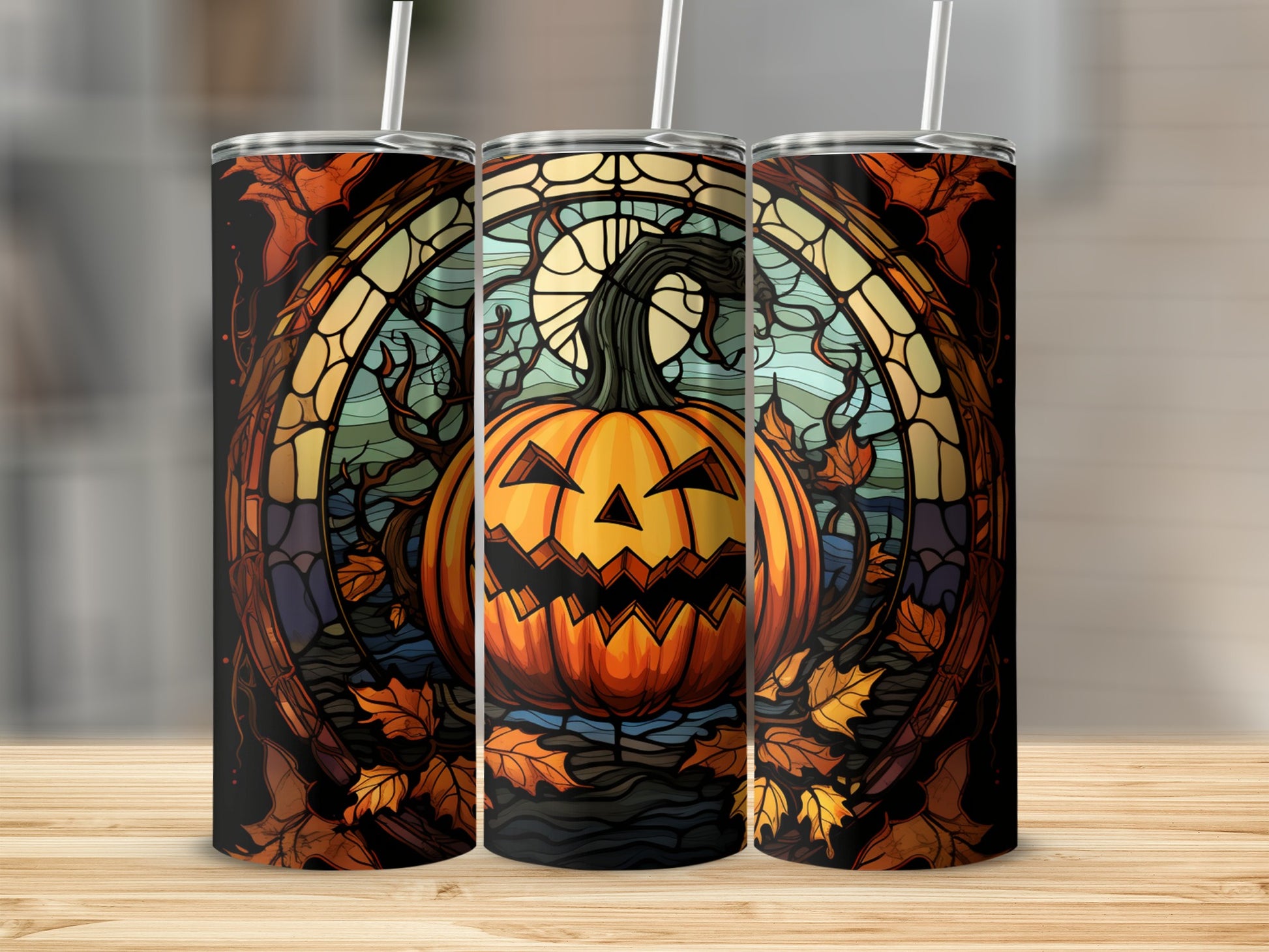 Jack-o'-lantern with stained glass-style Halloween design on three tumblers.
