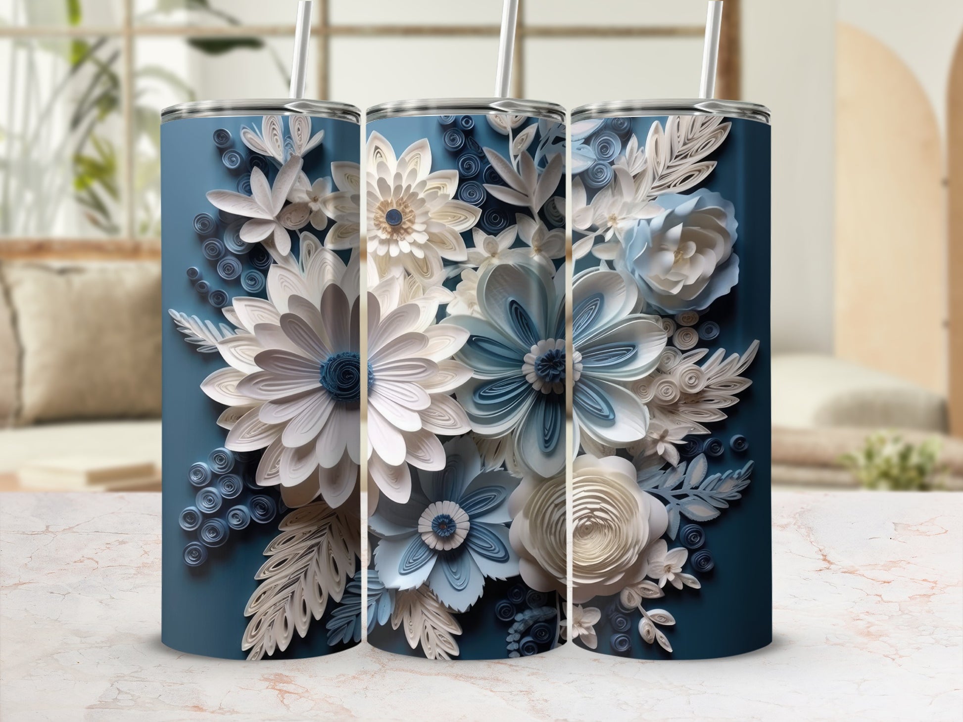 Three blue tumblers decorated with intricate paper flowers and leaves.