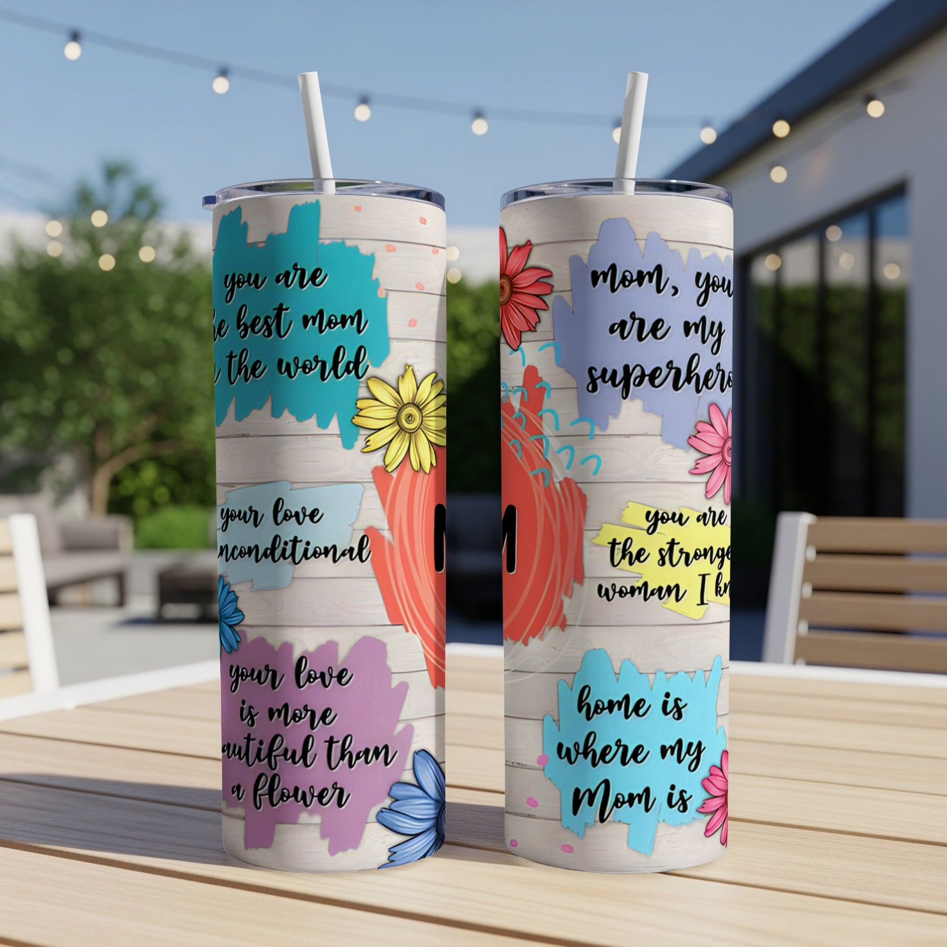 Two tumblers with colorful floral designs and maternal quotes, "Mom is where my home is."