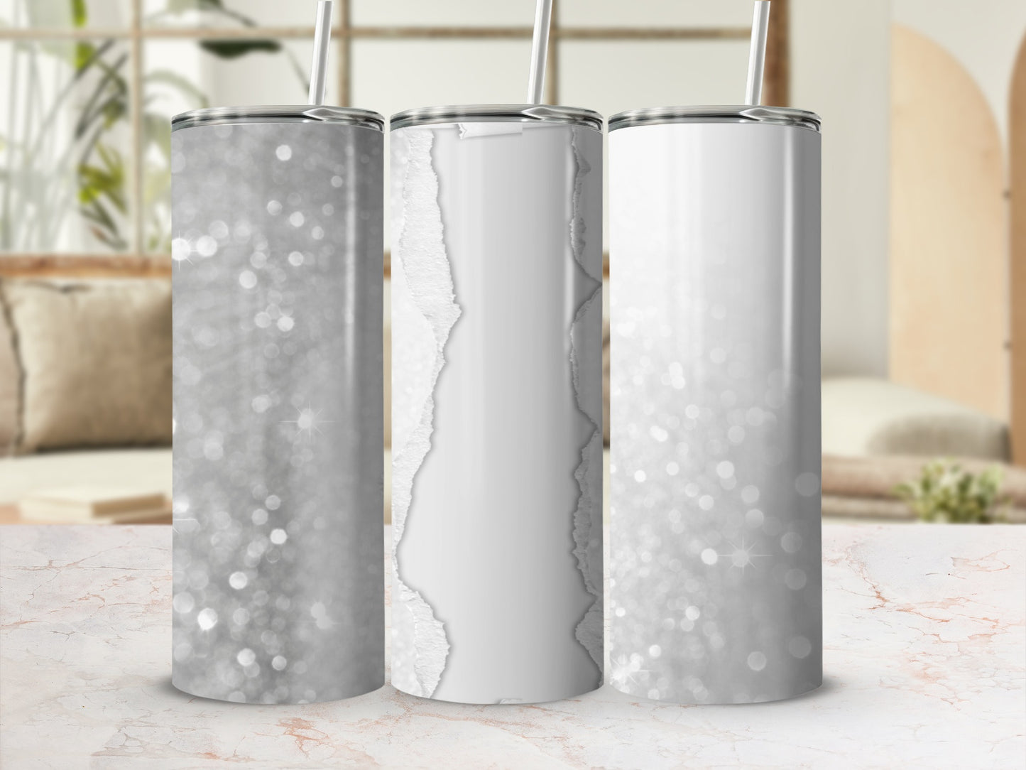 Three glittery tumblers with white torn paper accents and straws.