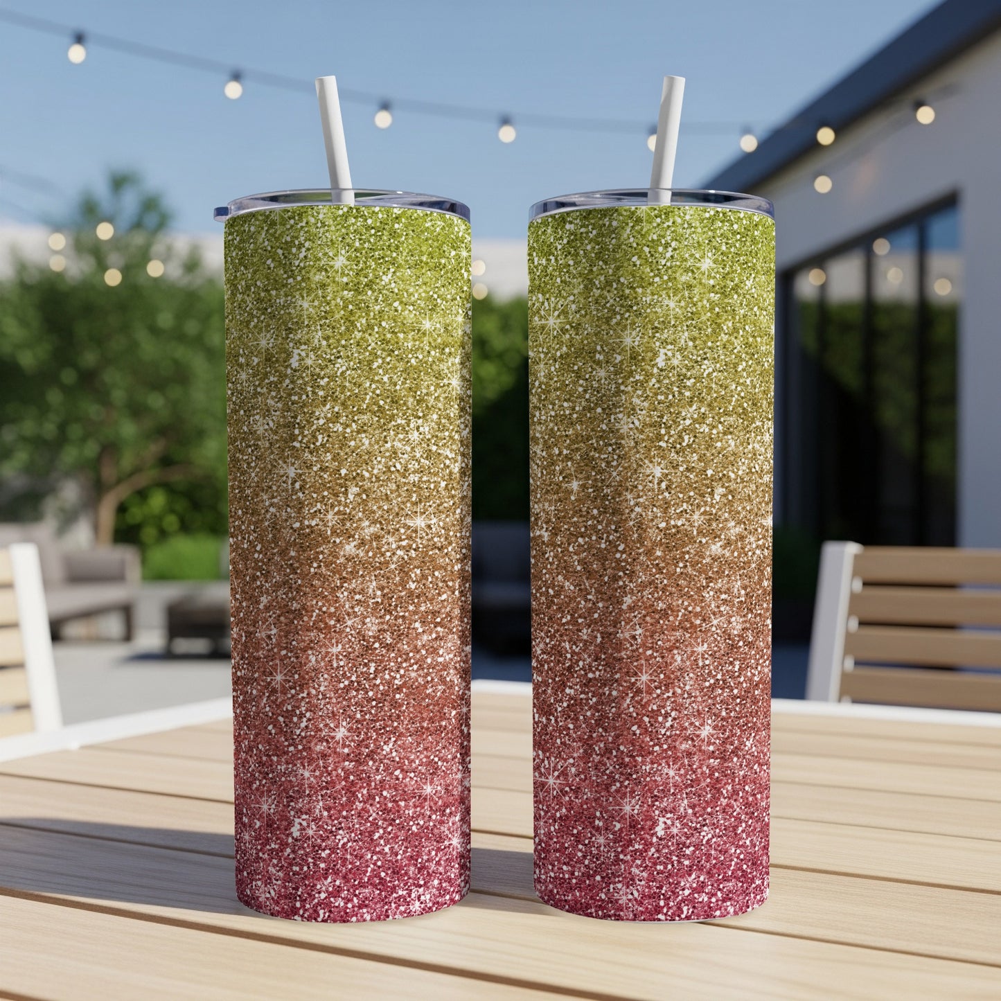 Two glitter tumblers with straws display a gradient of green, brown, and red.
