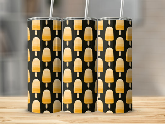 Three tumblers with a yellow popsicle pattern on a wooden surface.