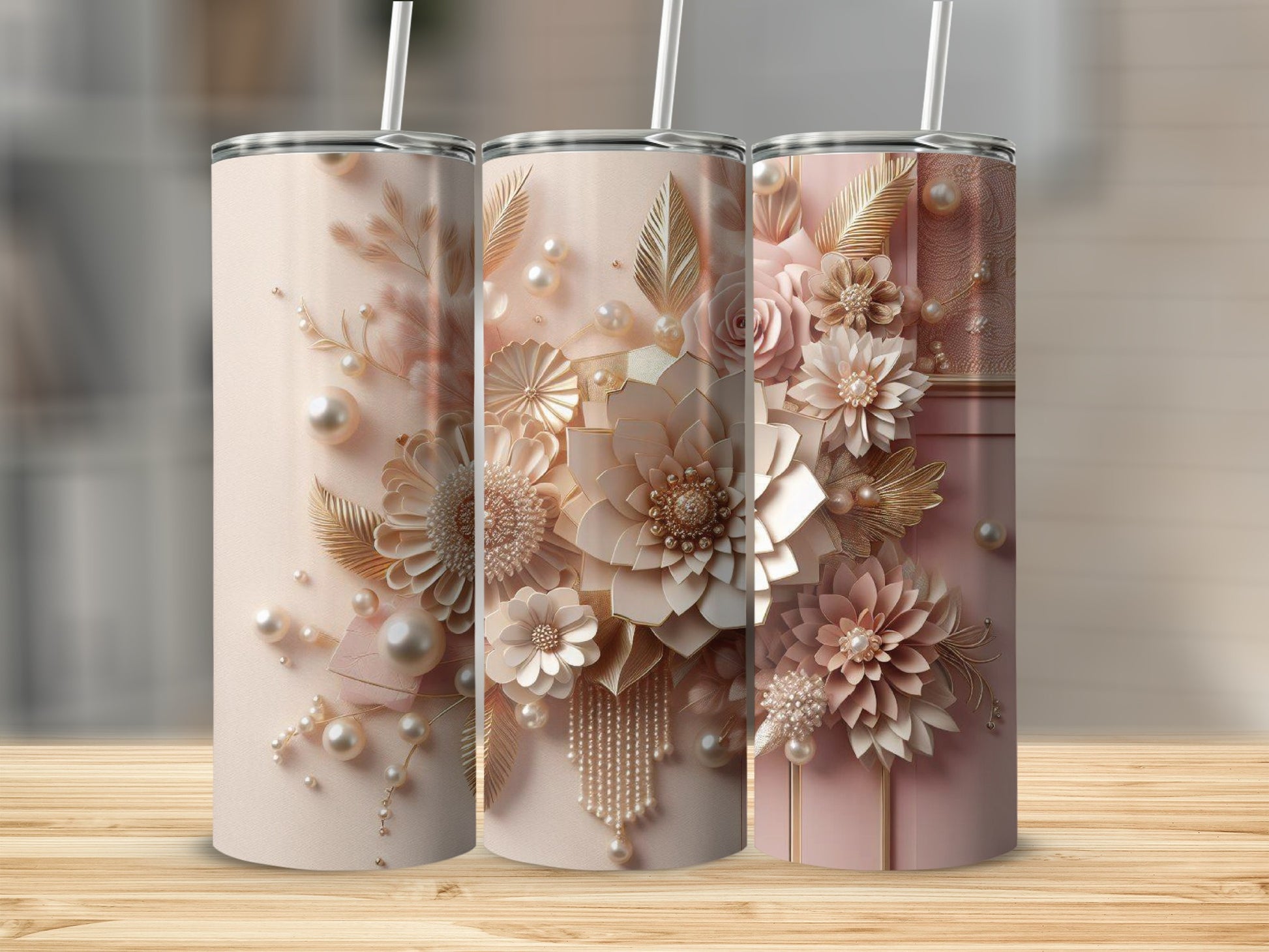 Three champagne-colored tumblers with ornate floral and pearl embellishments.