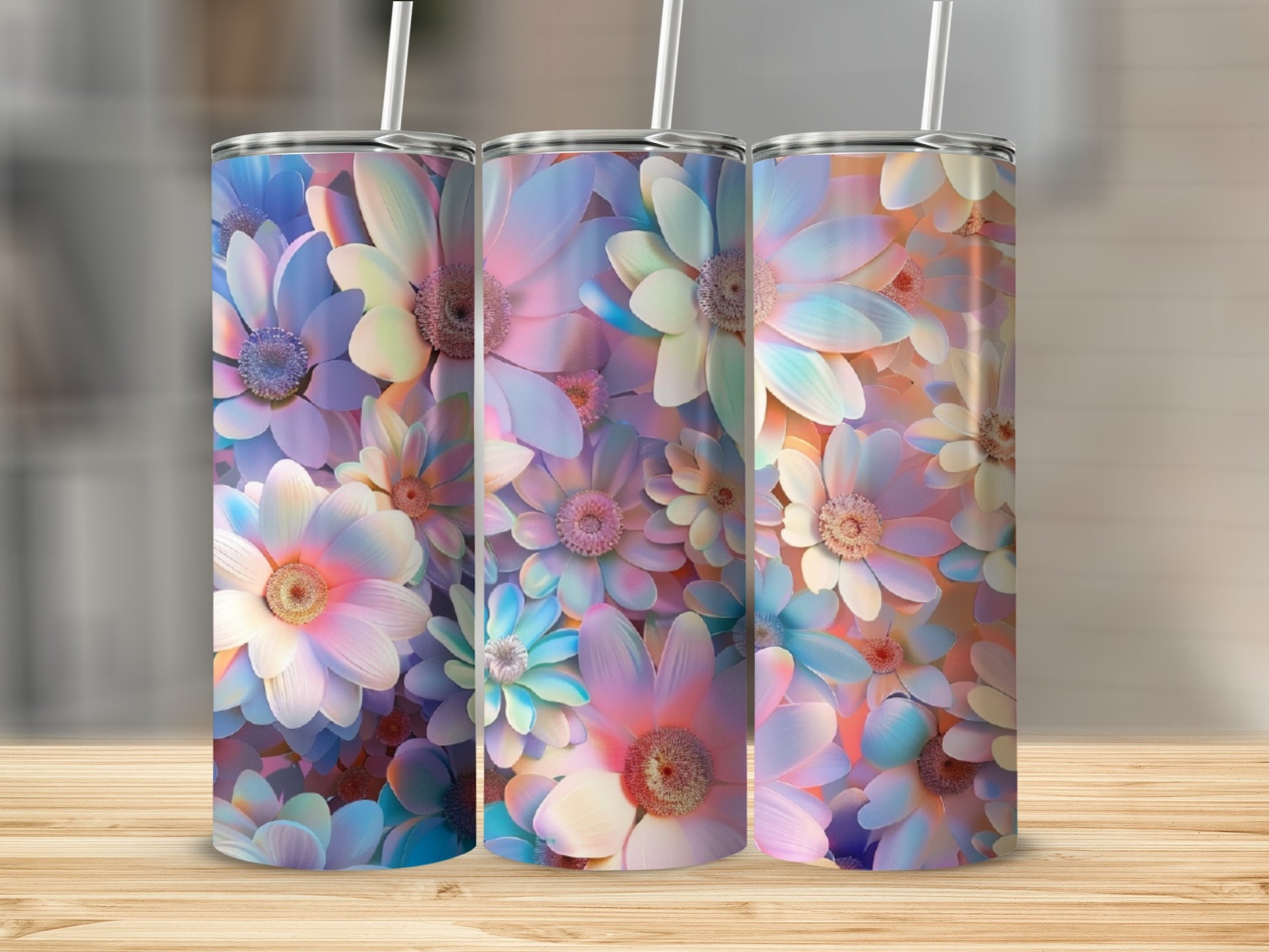 Three tall tumblers with pastel floral designs and white straws.