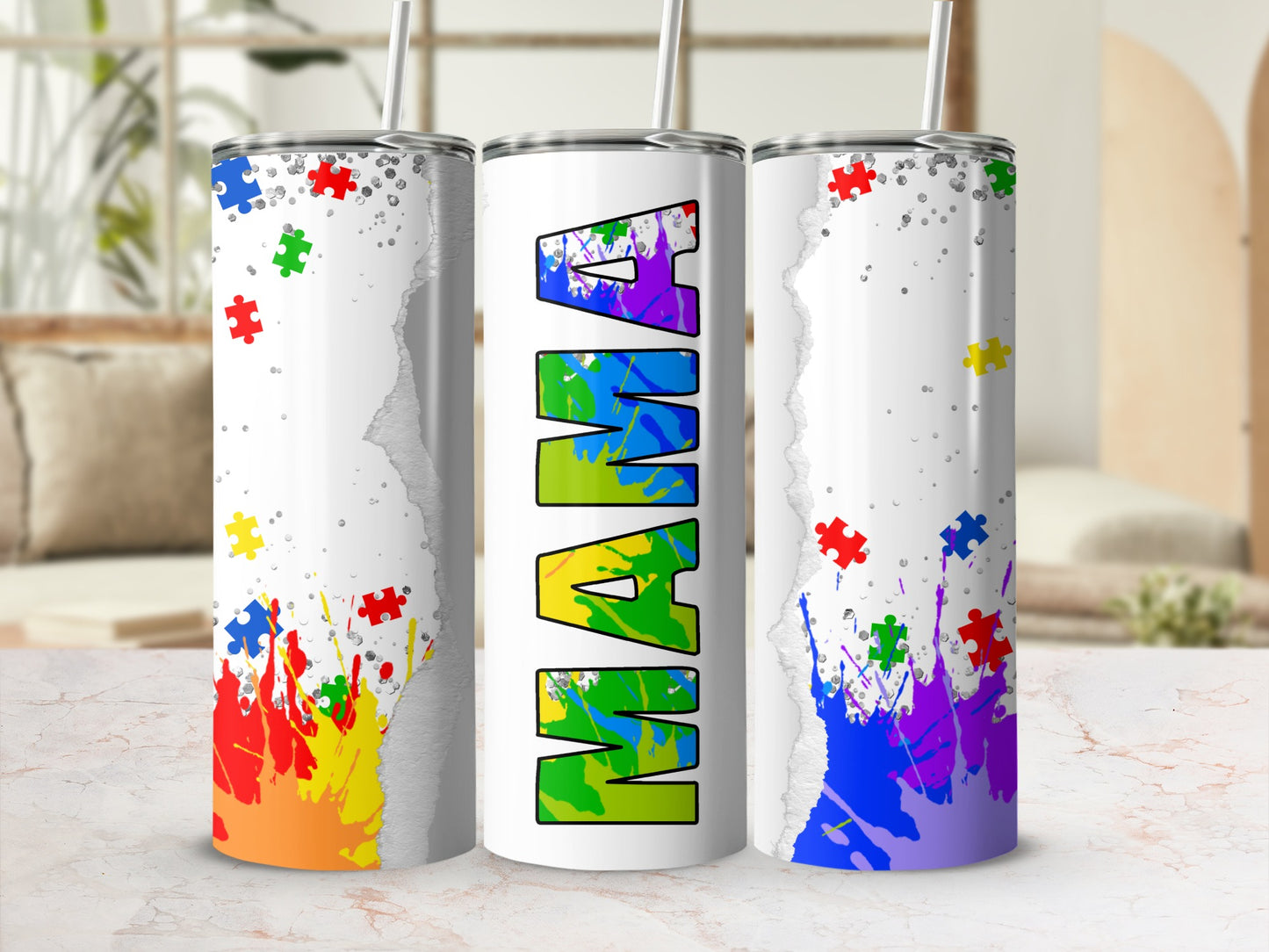 White tumbler with "MAMA" in colorful puzzle pieces and rainbow paint splatters.