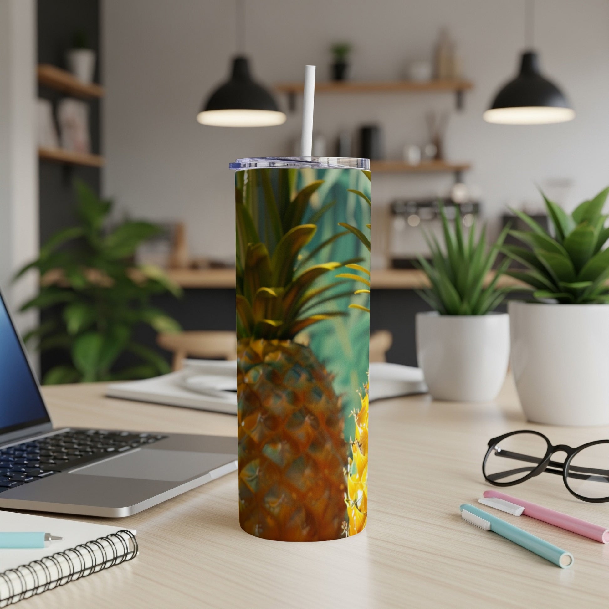 Tumbler with a close-up pineapple design on a desk.