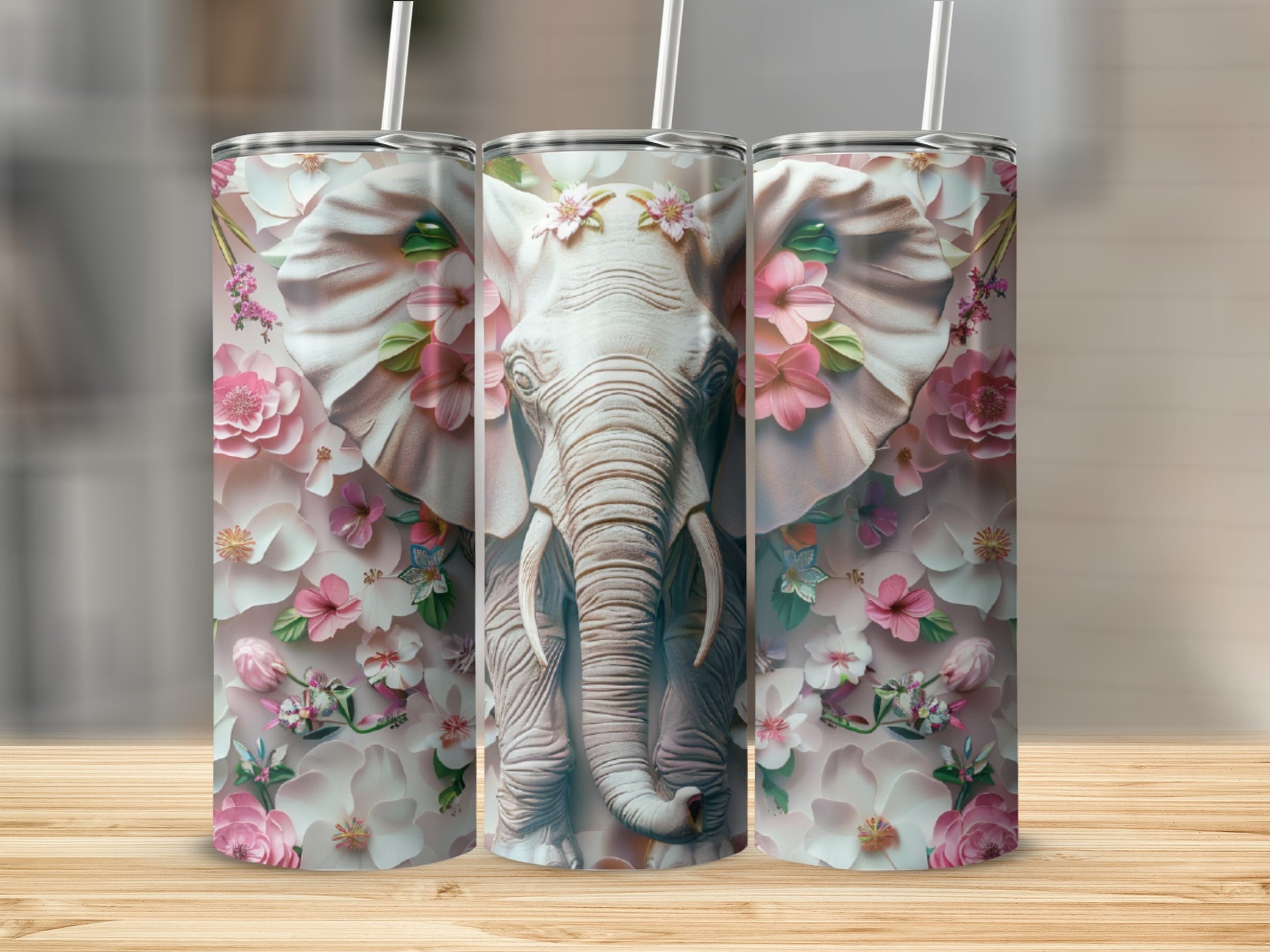 Three tumblers featuring a detailed elephant head with floral accents and pink and white flowers.