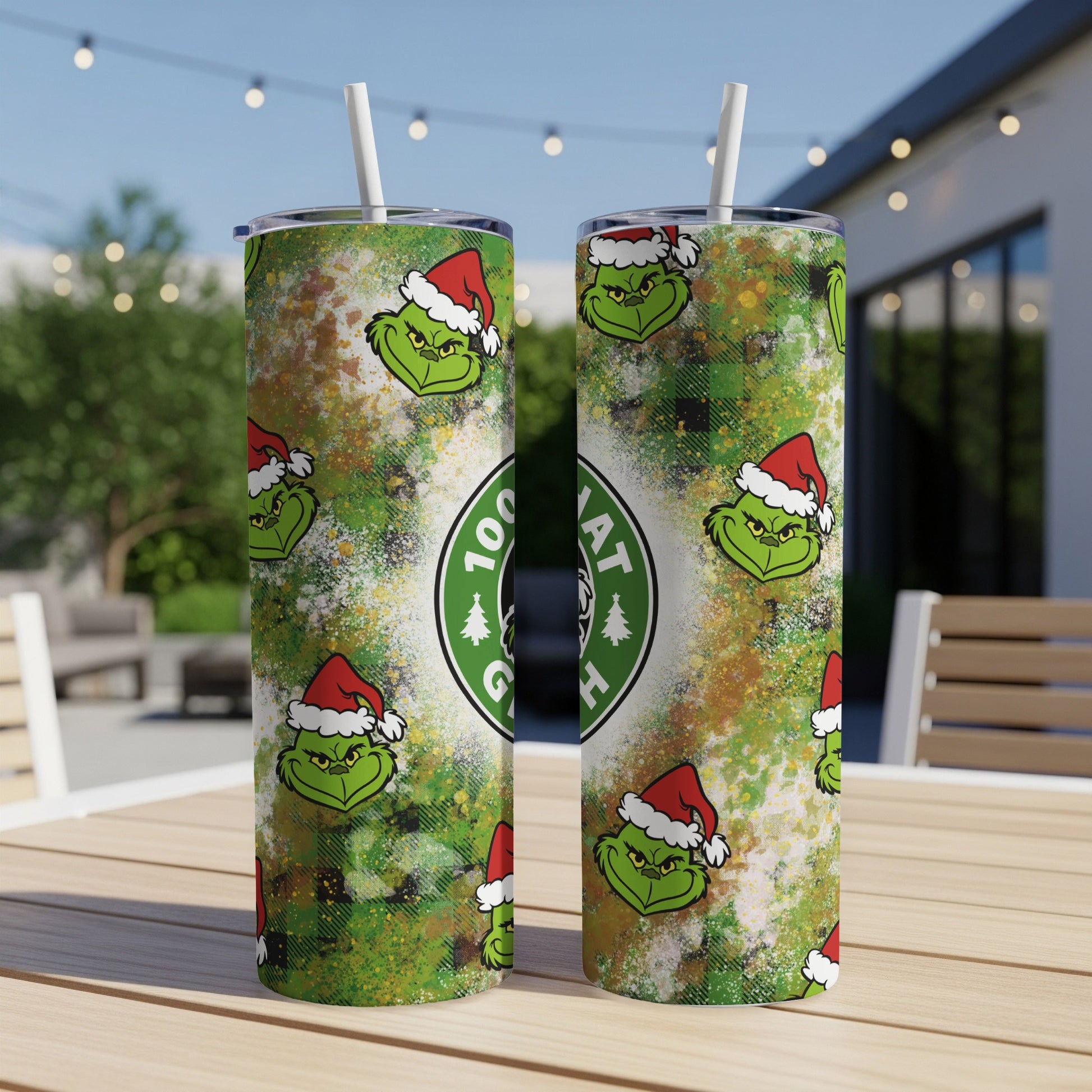 Two Grinch-themed tumblers with Christmas hats and a Starbucks logo.