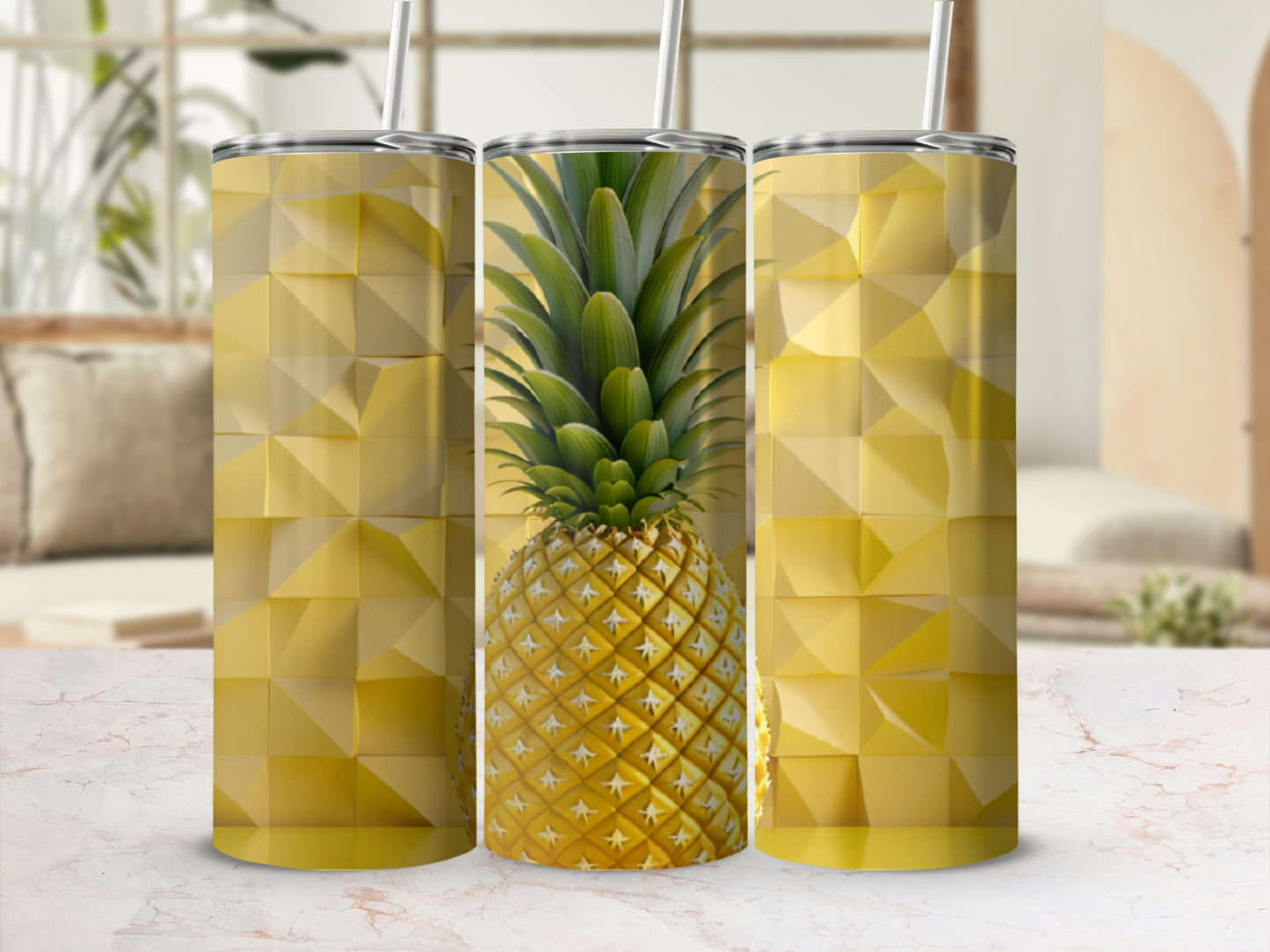 Three tumblers with a pineapple and geometric pattern on a patterned surface.