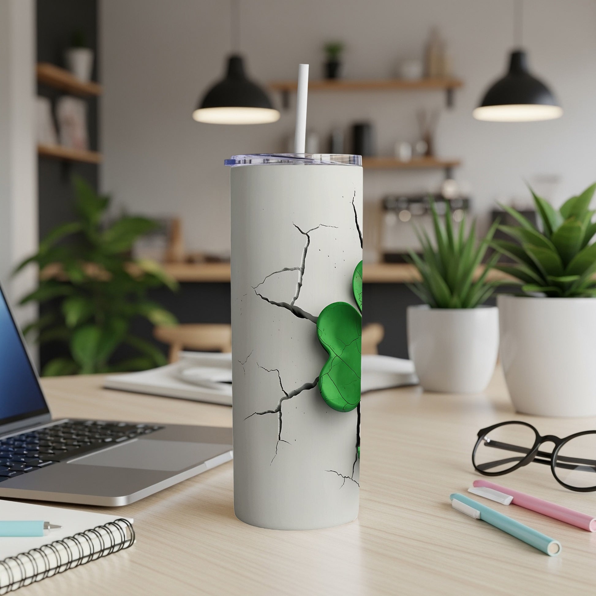 White tumbler with cracked design and a green clover.