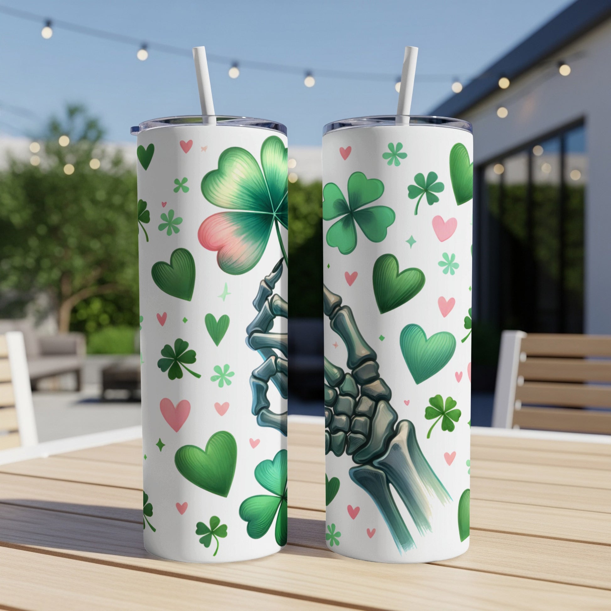 Skeleton hand holding a shamrock on a skinny tumbler with green hearts.