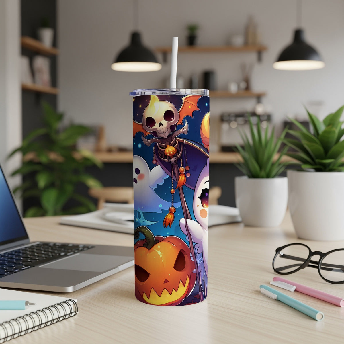Halloween themed tumbler with pumpkin, ghost, and skeleton art, with a straw.